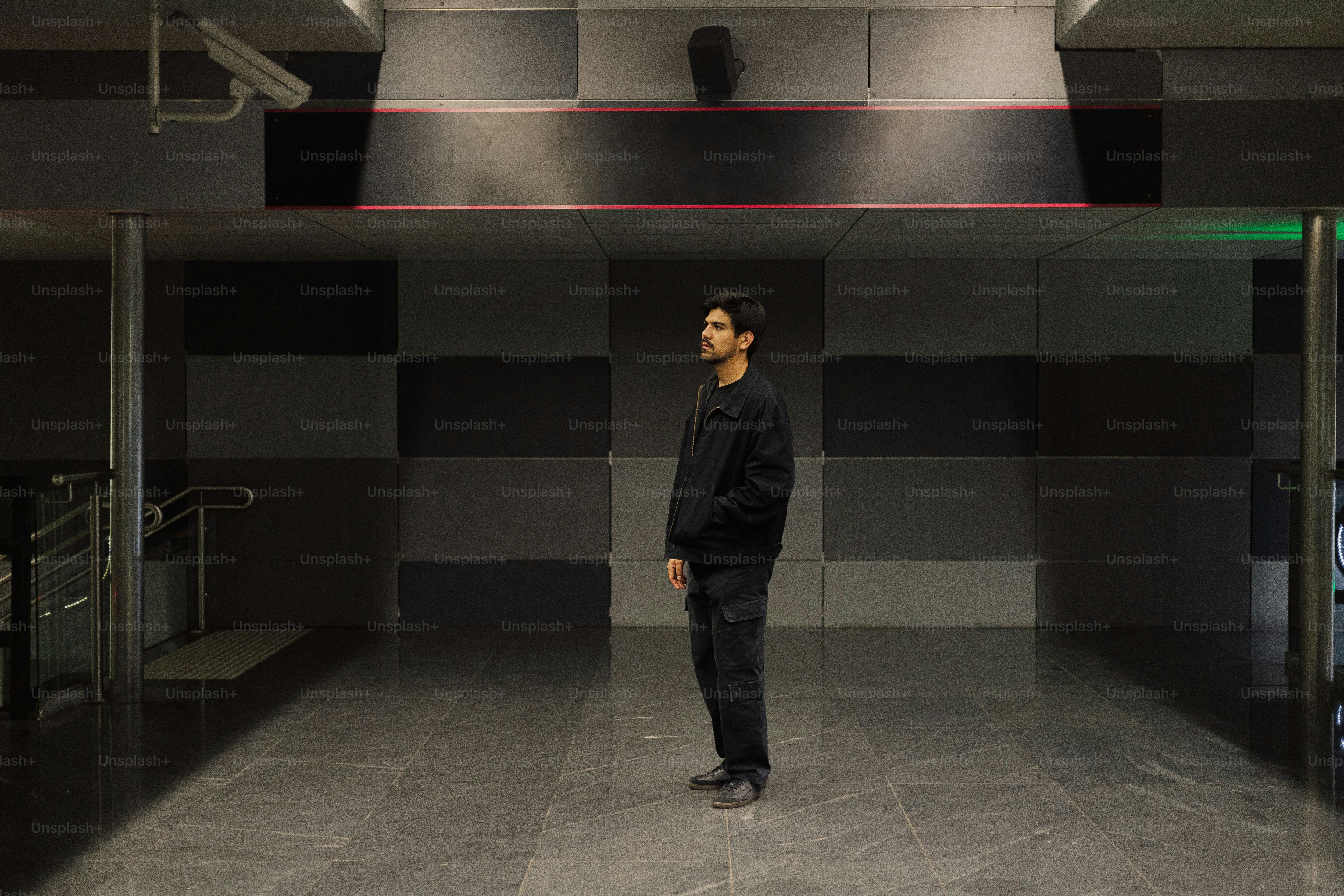 A man standing in a room with a black suit