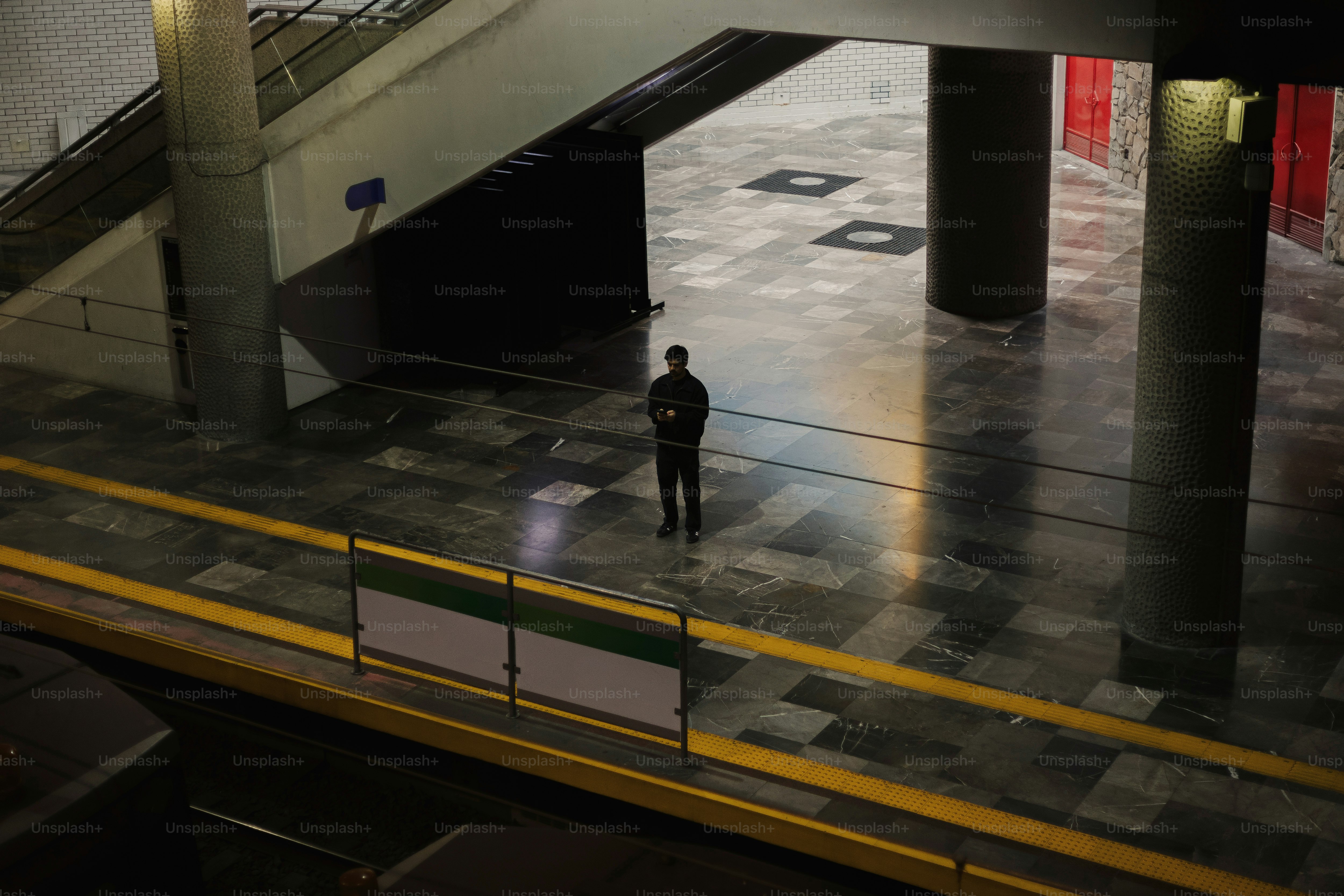A man is standing in the middle of a walkway
