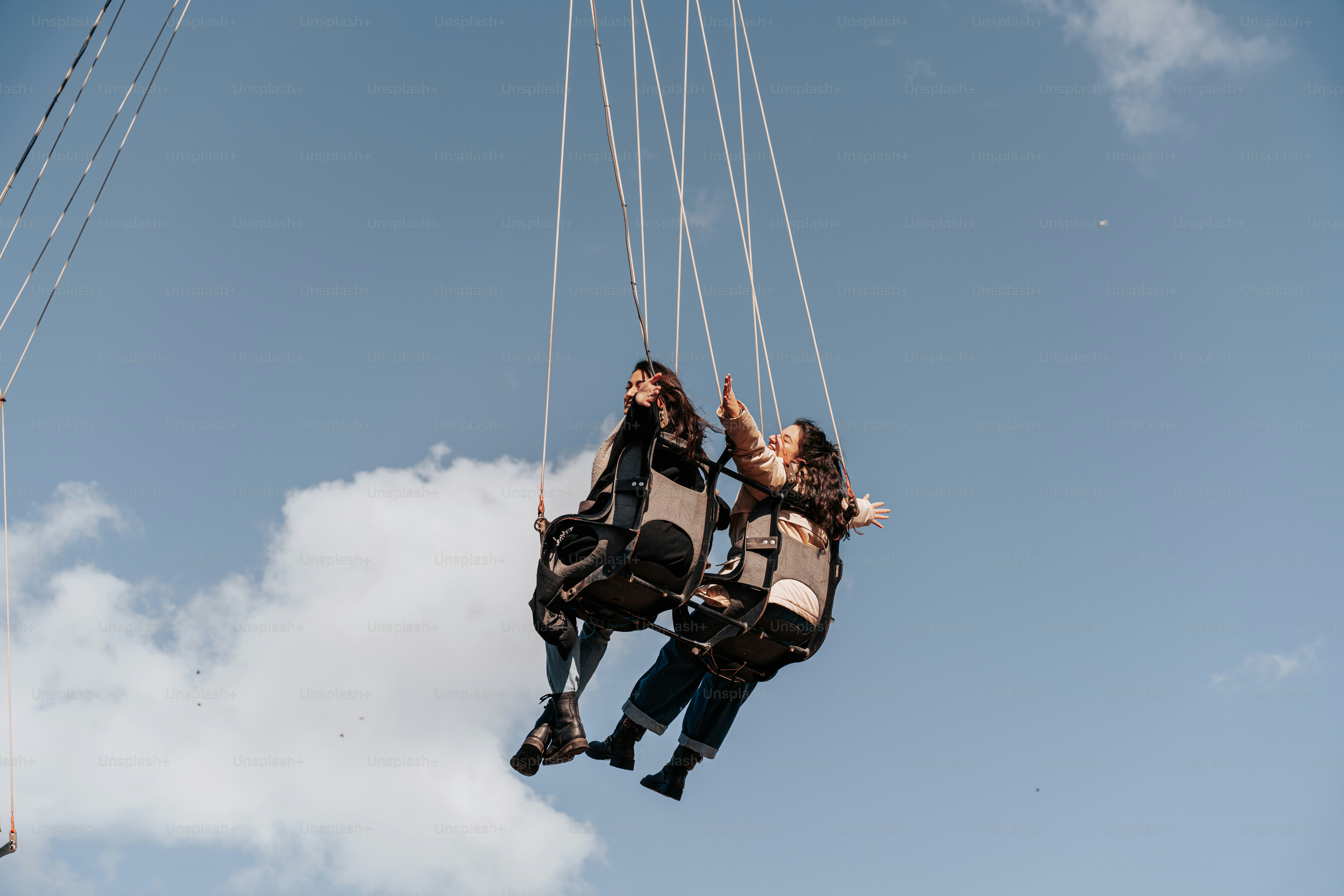 A couple of people riding on top of a parachute