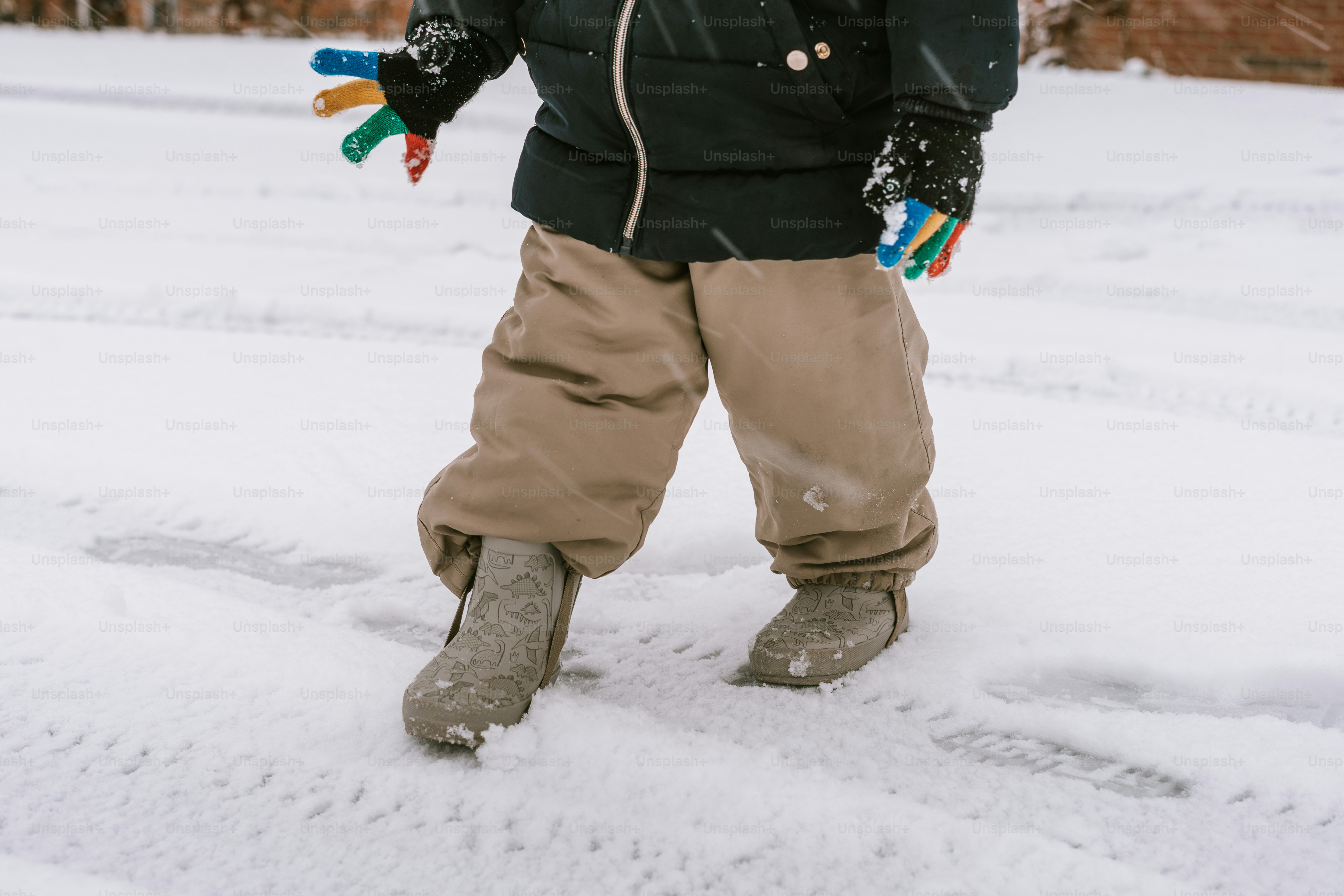 A man standing in the snow with a pair of skis