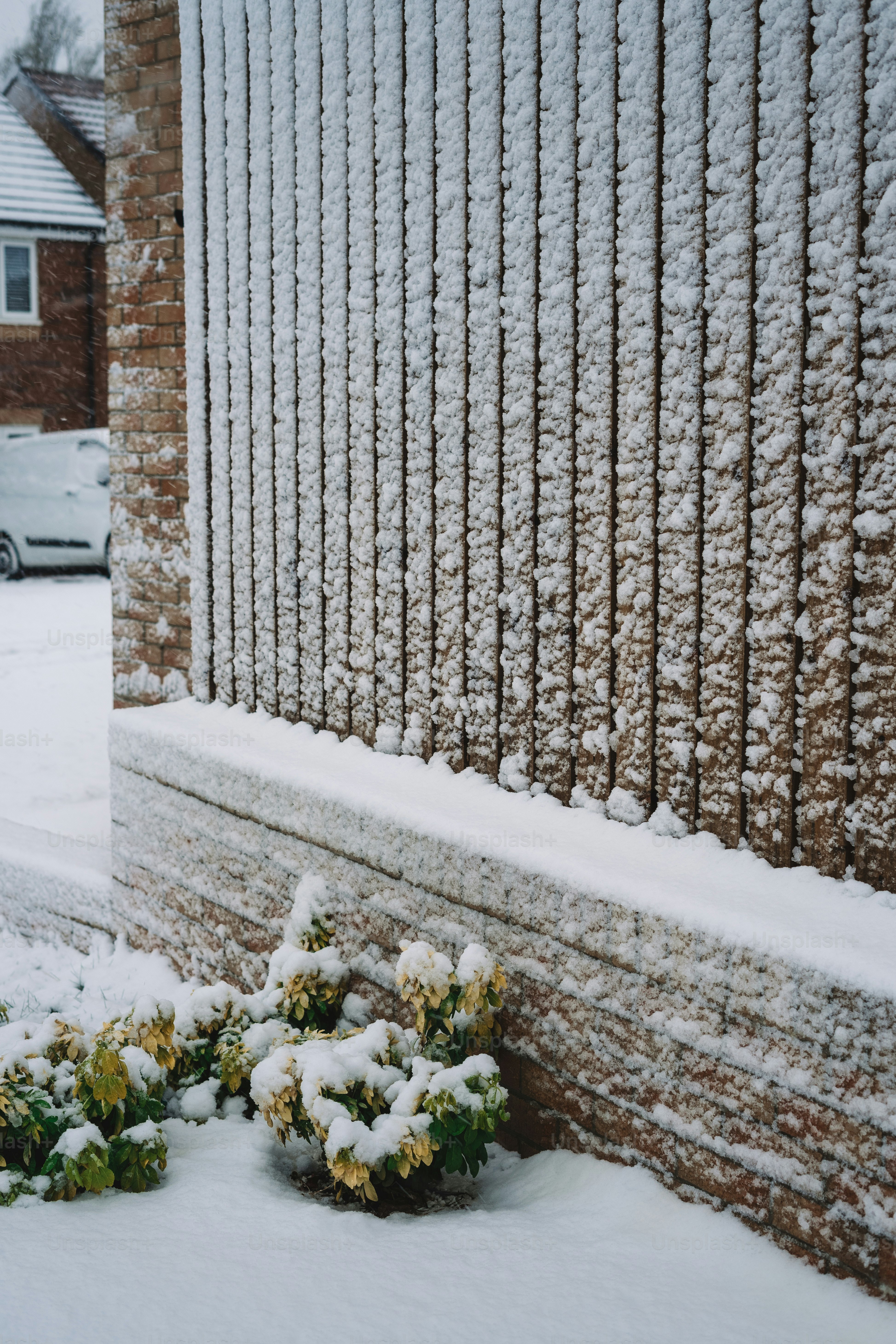 A snow covered sidewalk next to a building