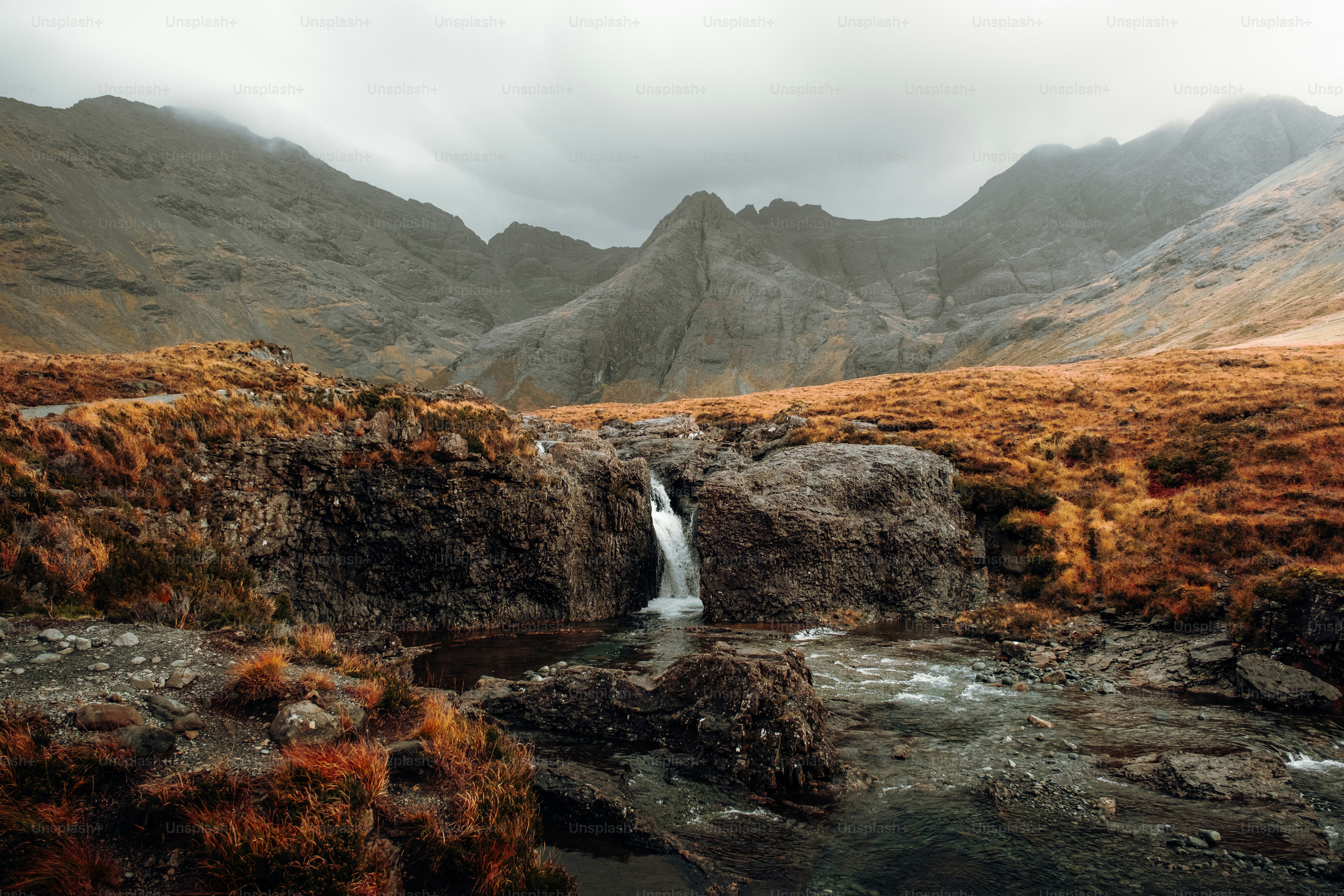 A small waterfall in the middle of a mountain range