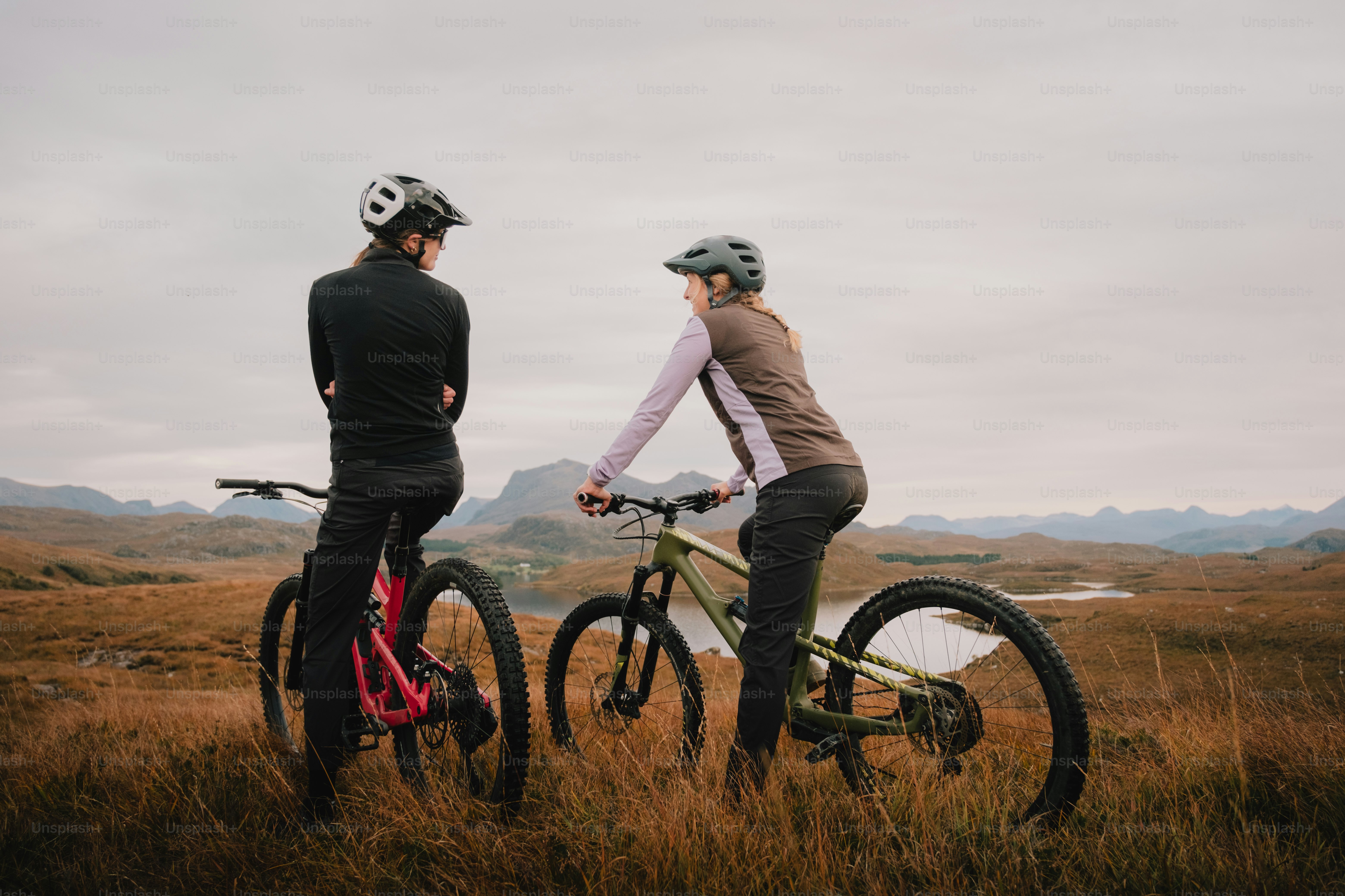 A couple of people on bikes in a field