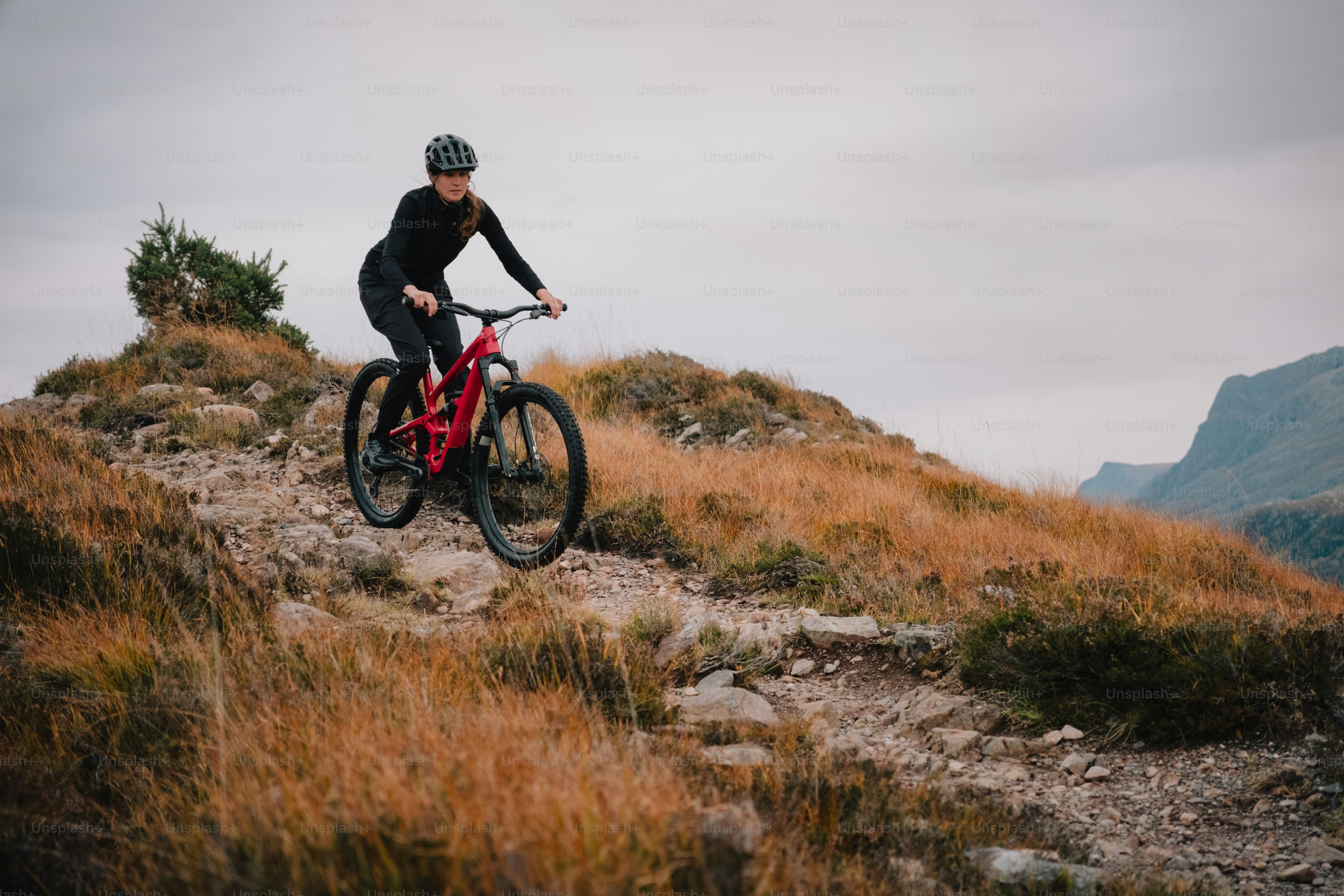 A man riding a mountain bike down a hill