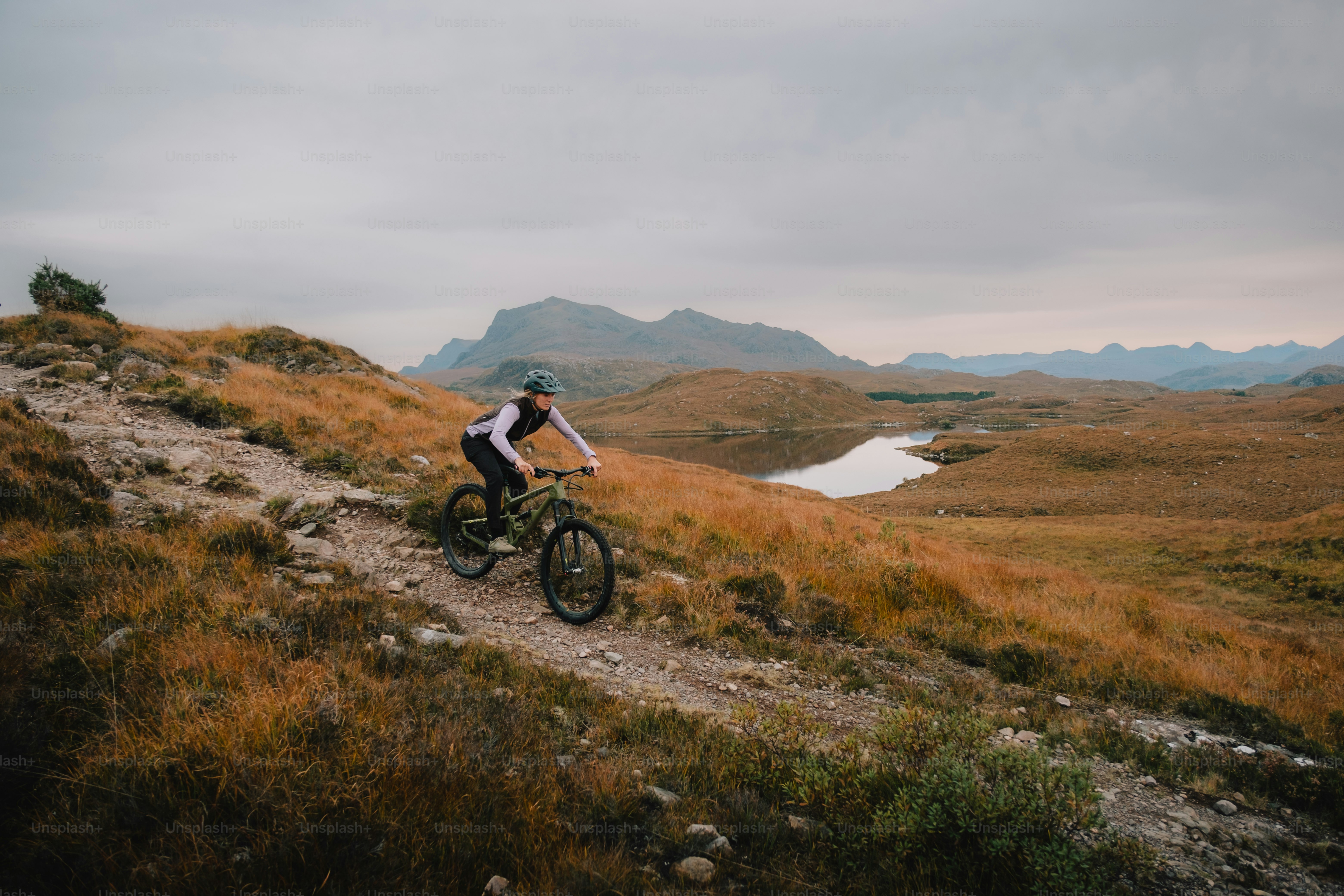 A man riding a bike down a dirt road