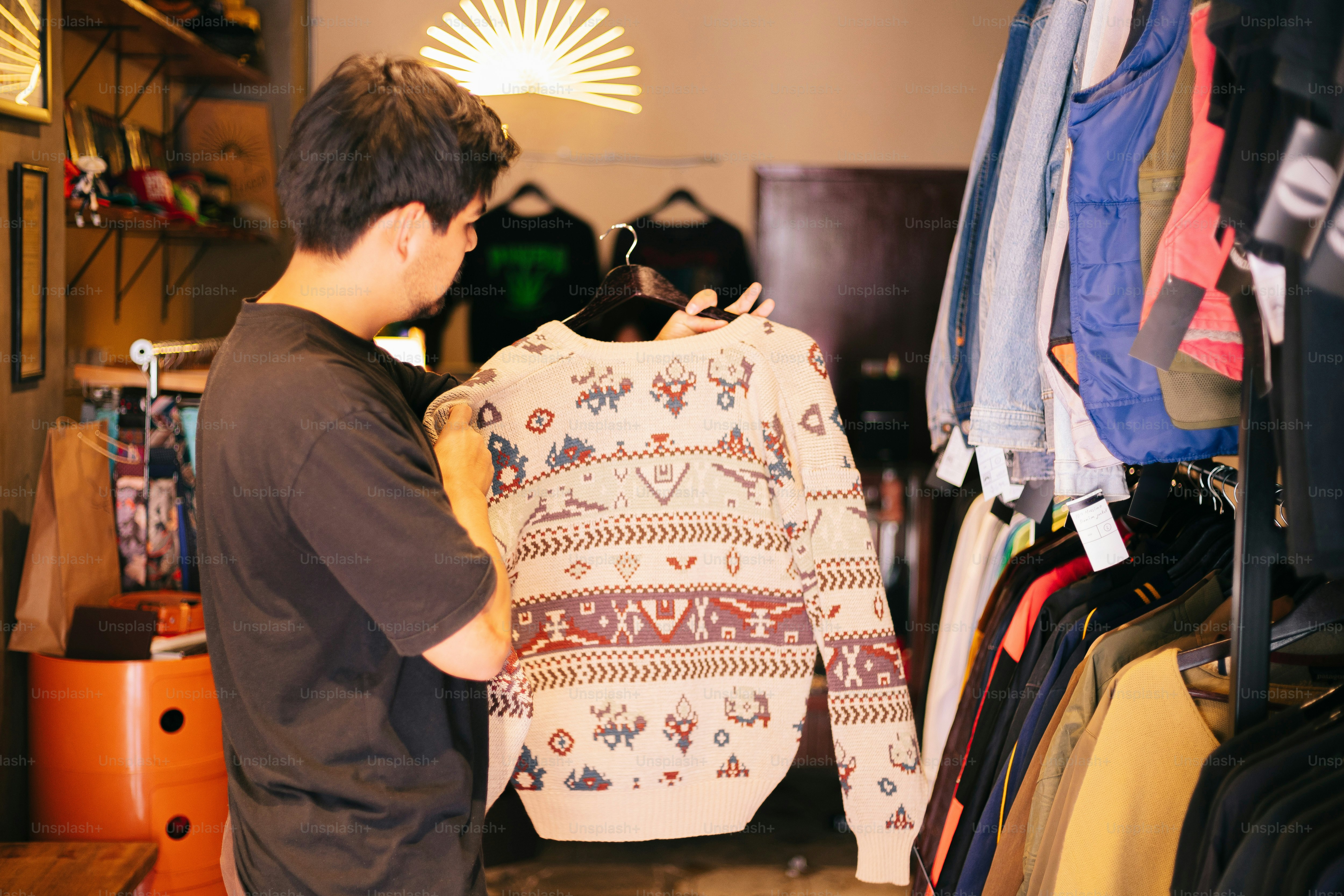 A man is looking at a bag in a closet