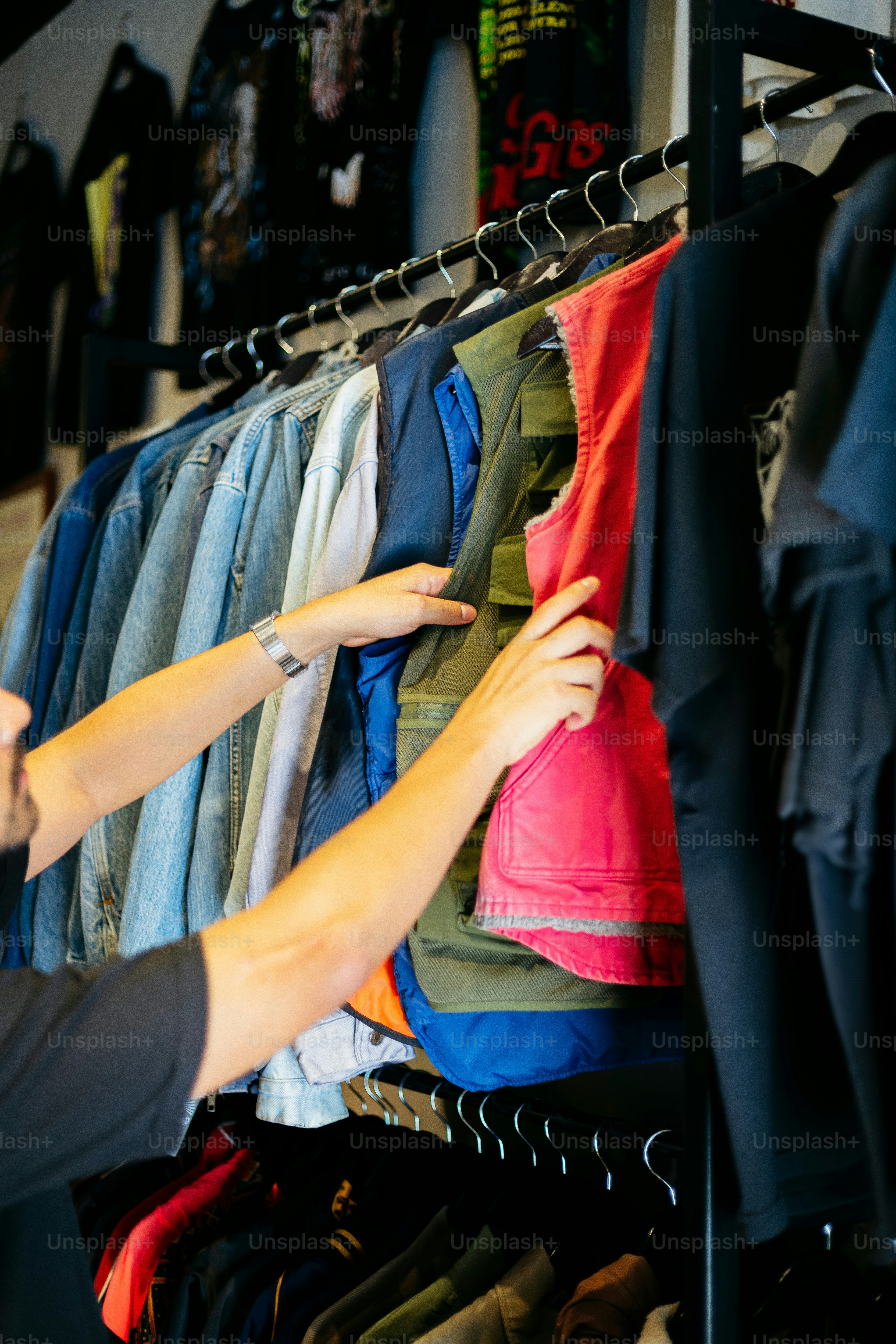 A woman looking at a rack of clothes