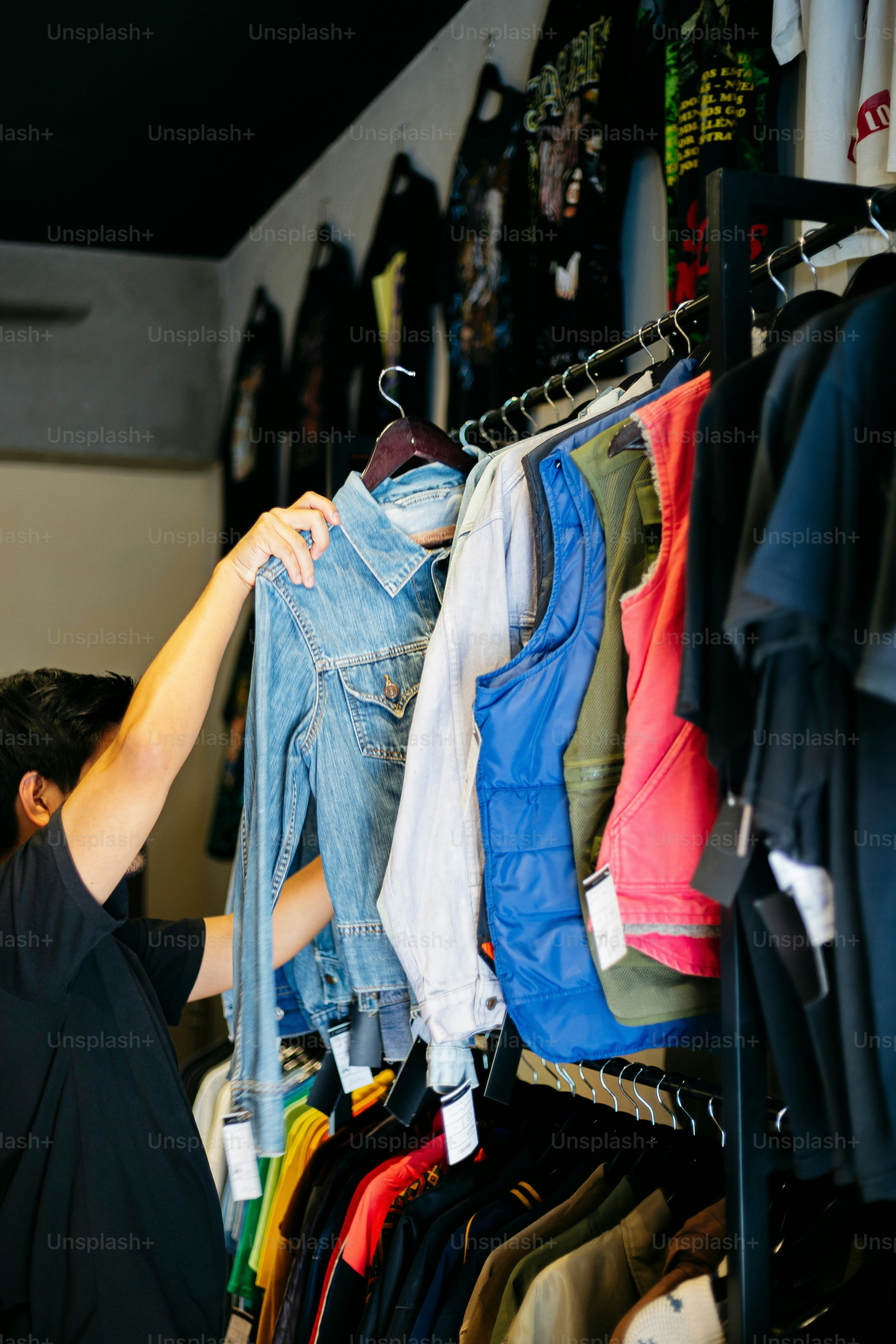 A man looking at a rack of clothes