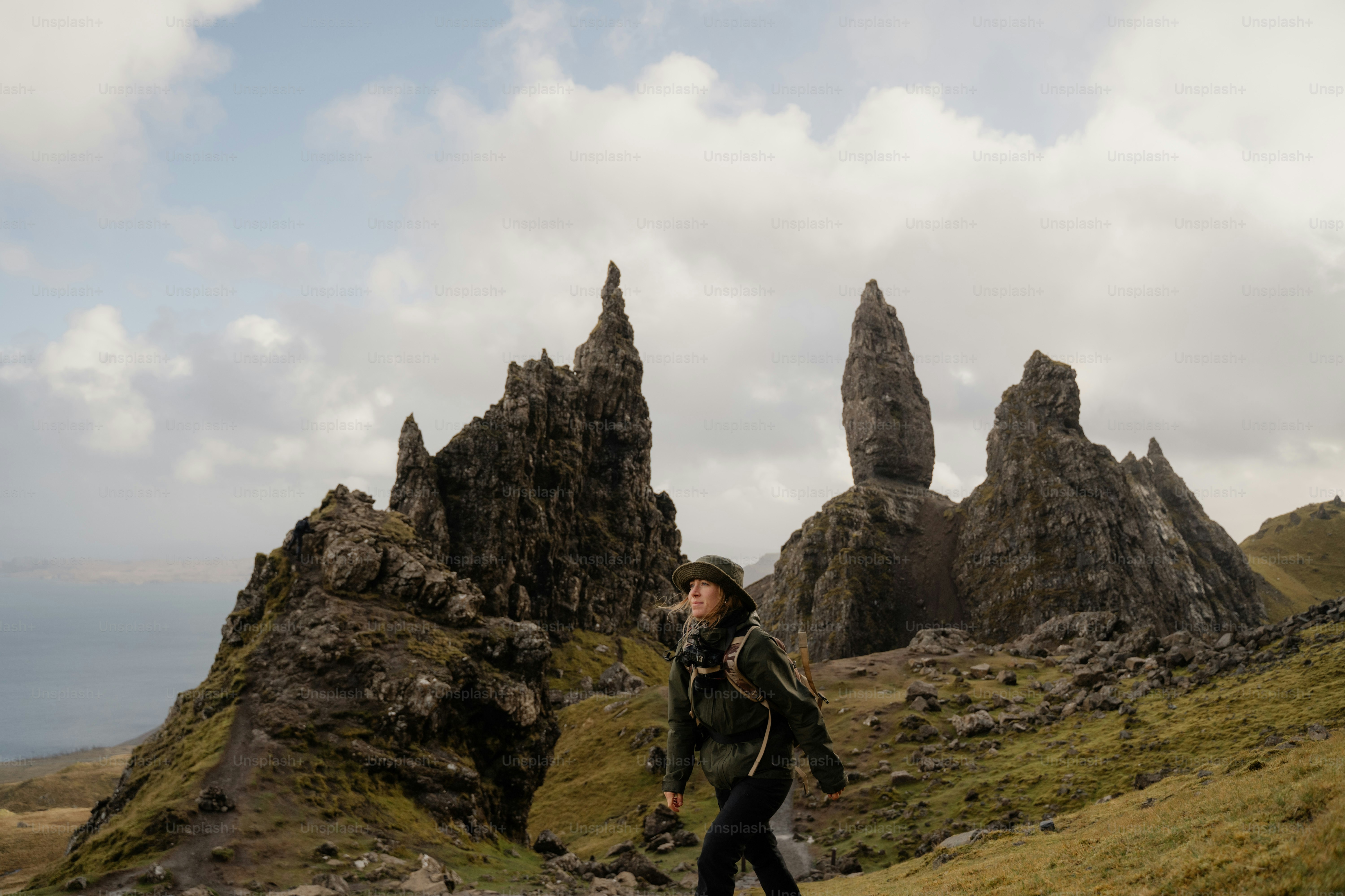 A man is walking on a grassy hill