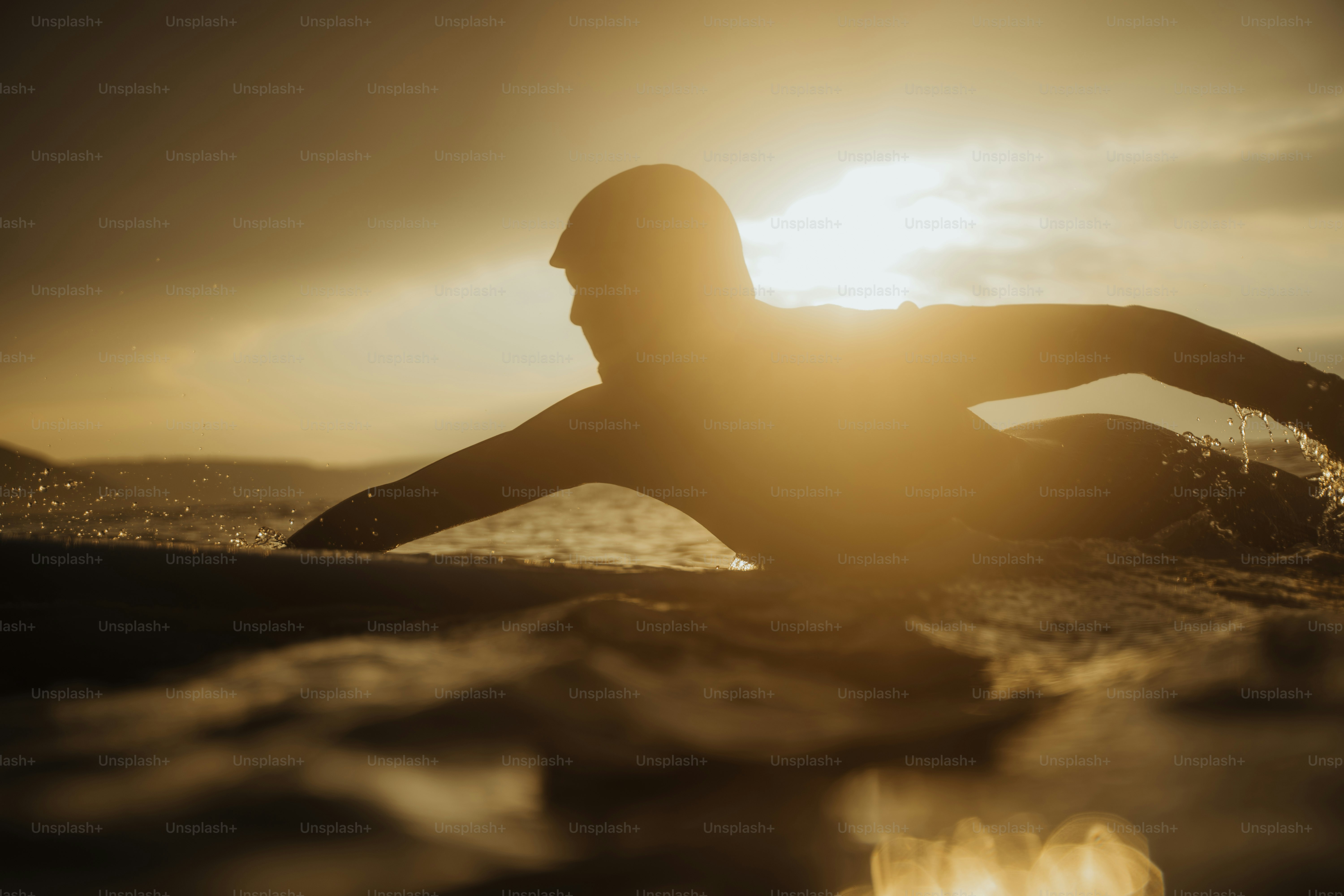 A woman riding a surfboard on top of a wave photo – Travel Image on ...