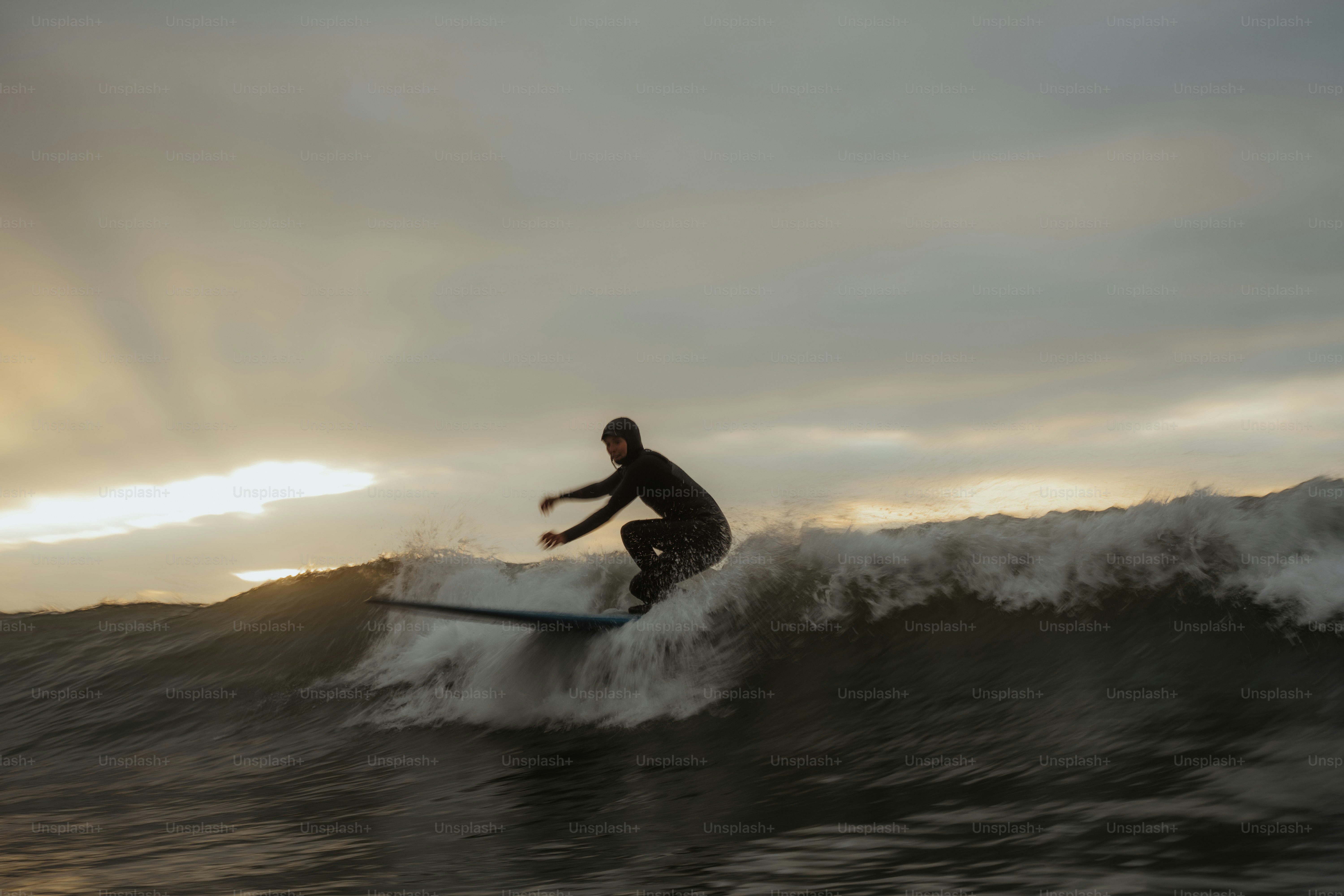 A man riding a wave on top of a surfboard photo – Surfing Image on Unsplash