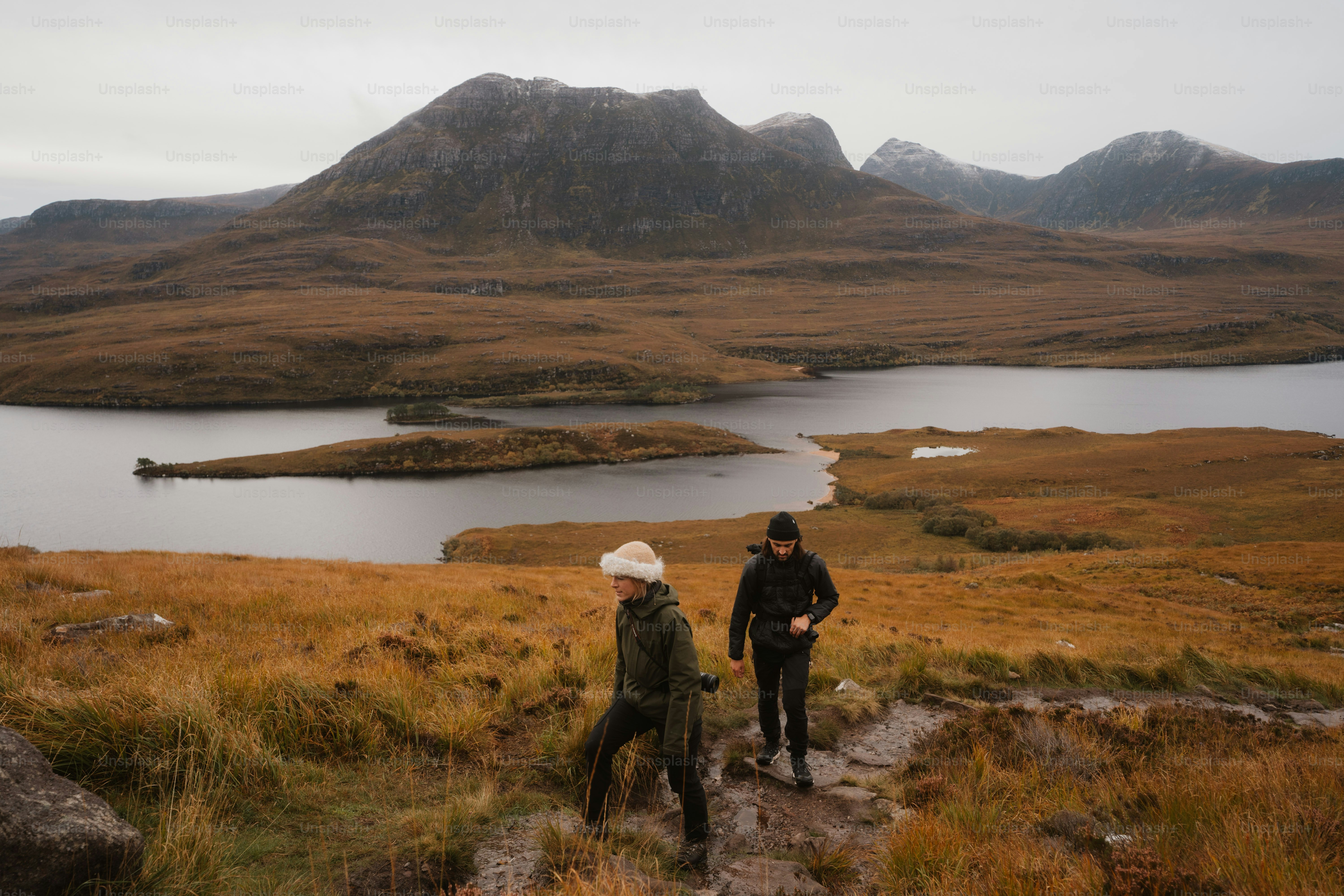 A couple of people that are standing in the grass