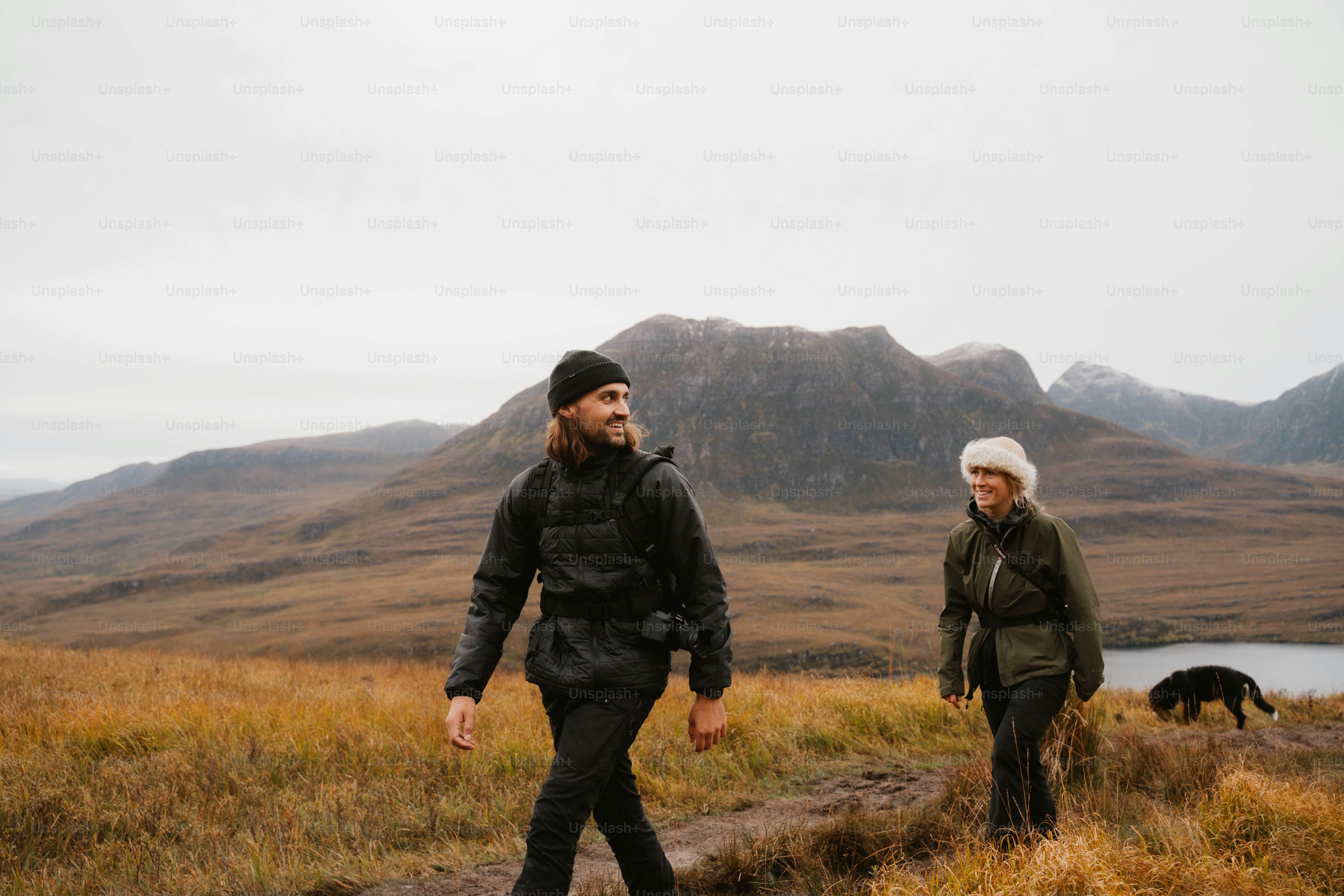 A man and a woman walking in a field
