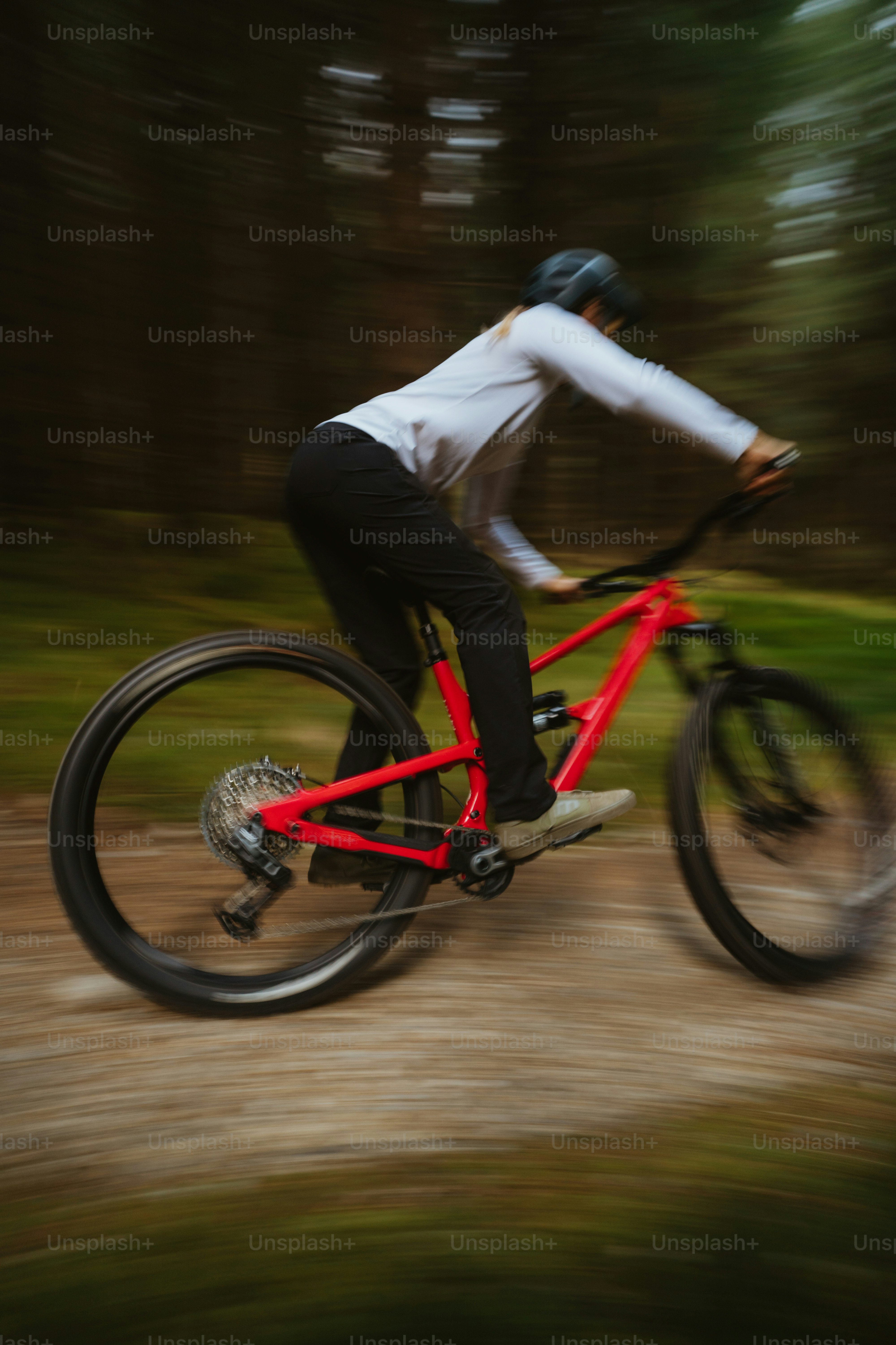 A man riding a bike down a dirt road