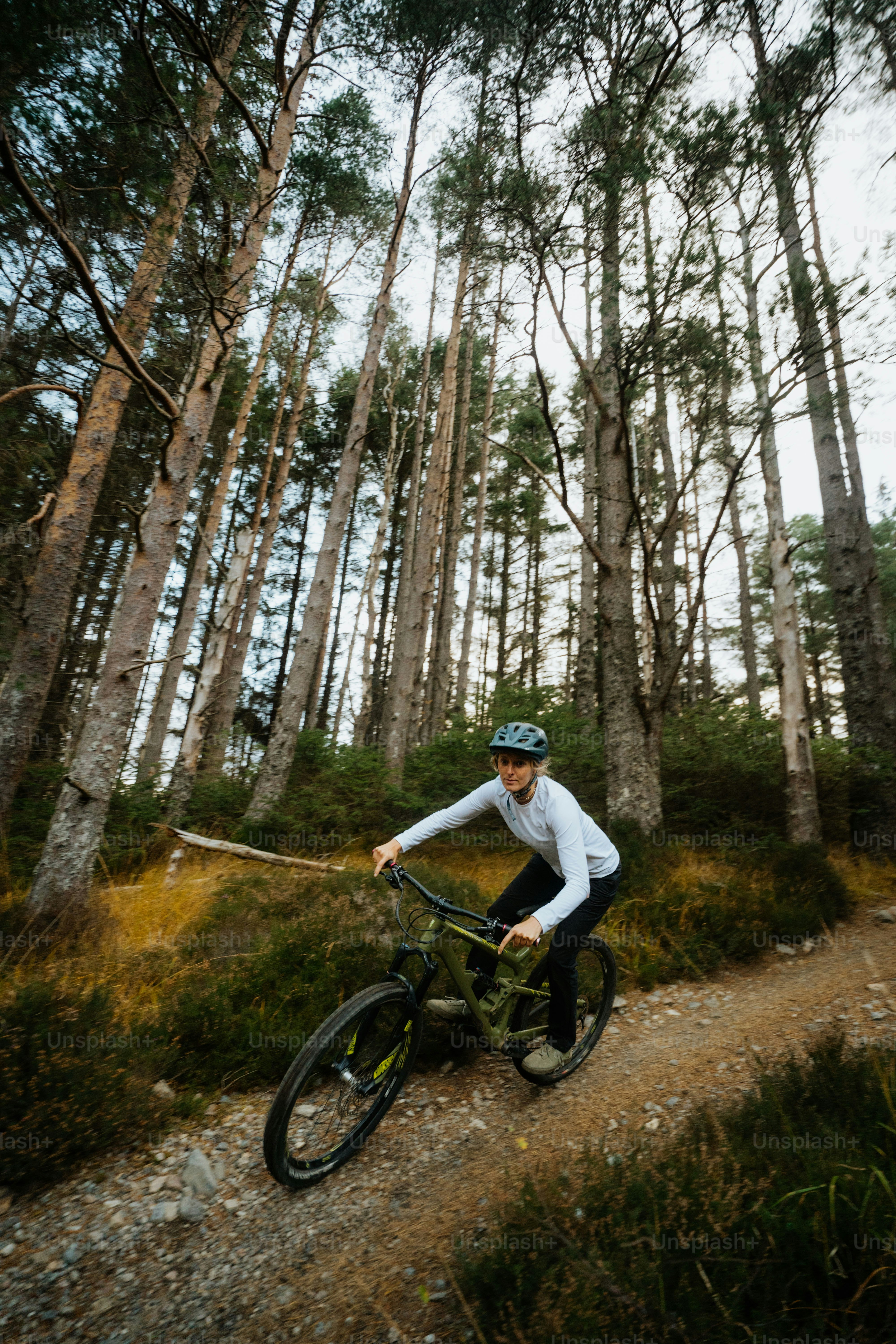 A man riding a bike down a dirt road