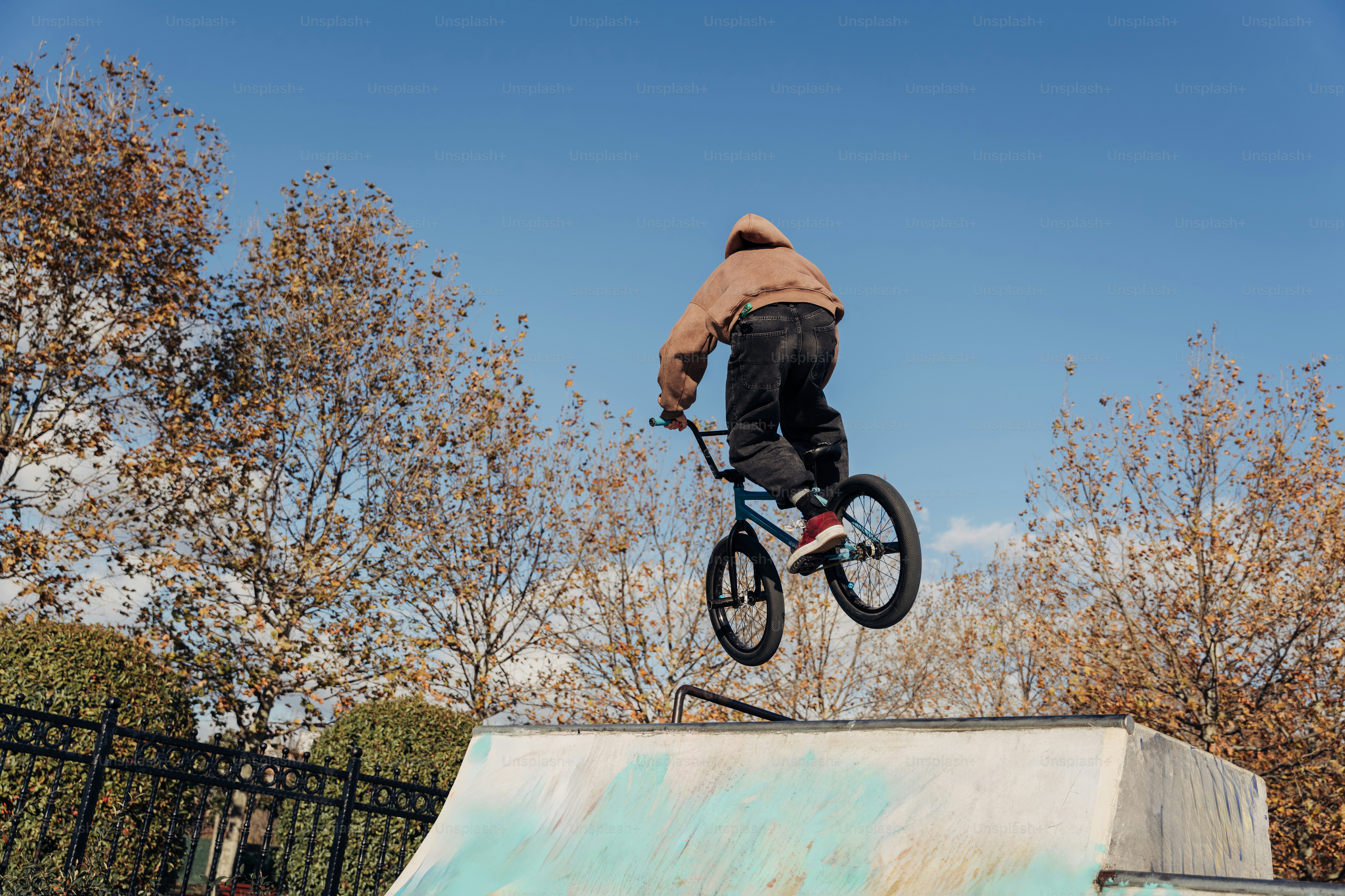 A man riding a bike up the side of a ramp photo – Sport Image on Unsplash