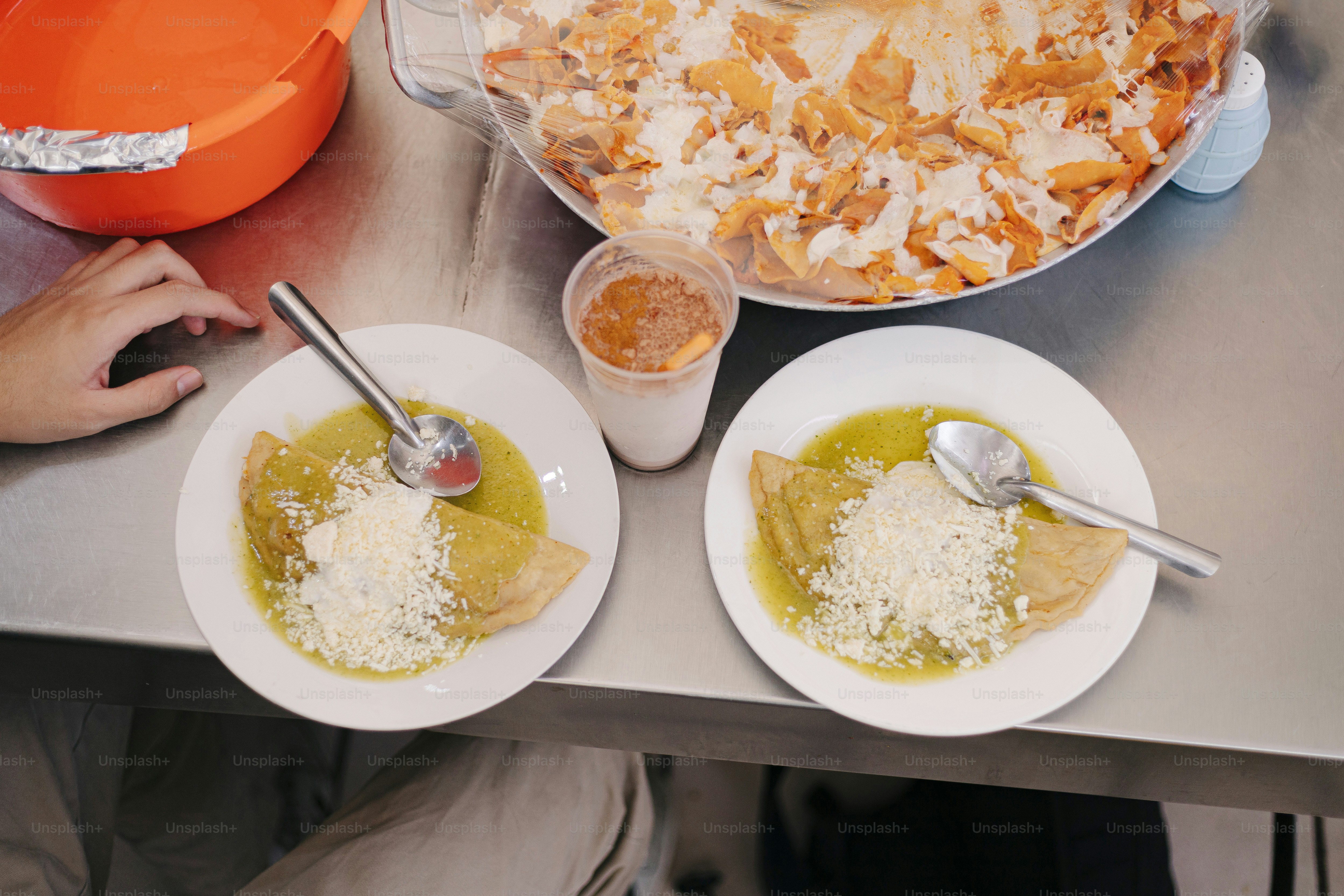 A table topped with plates of food and bowls of soup