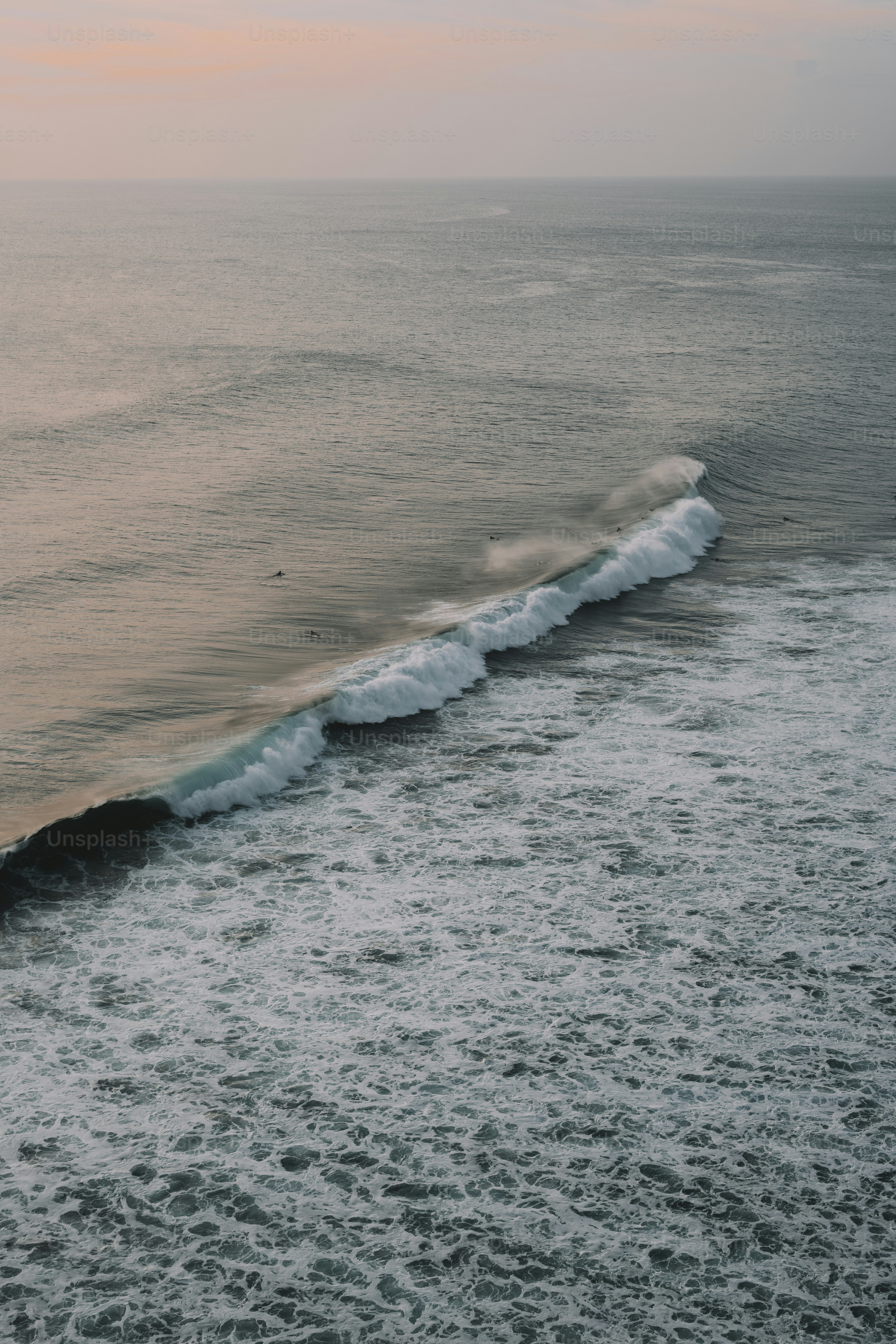 A person riding a surfboard on a wave in the ocean