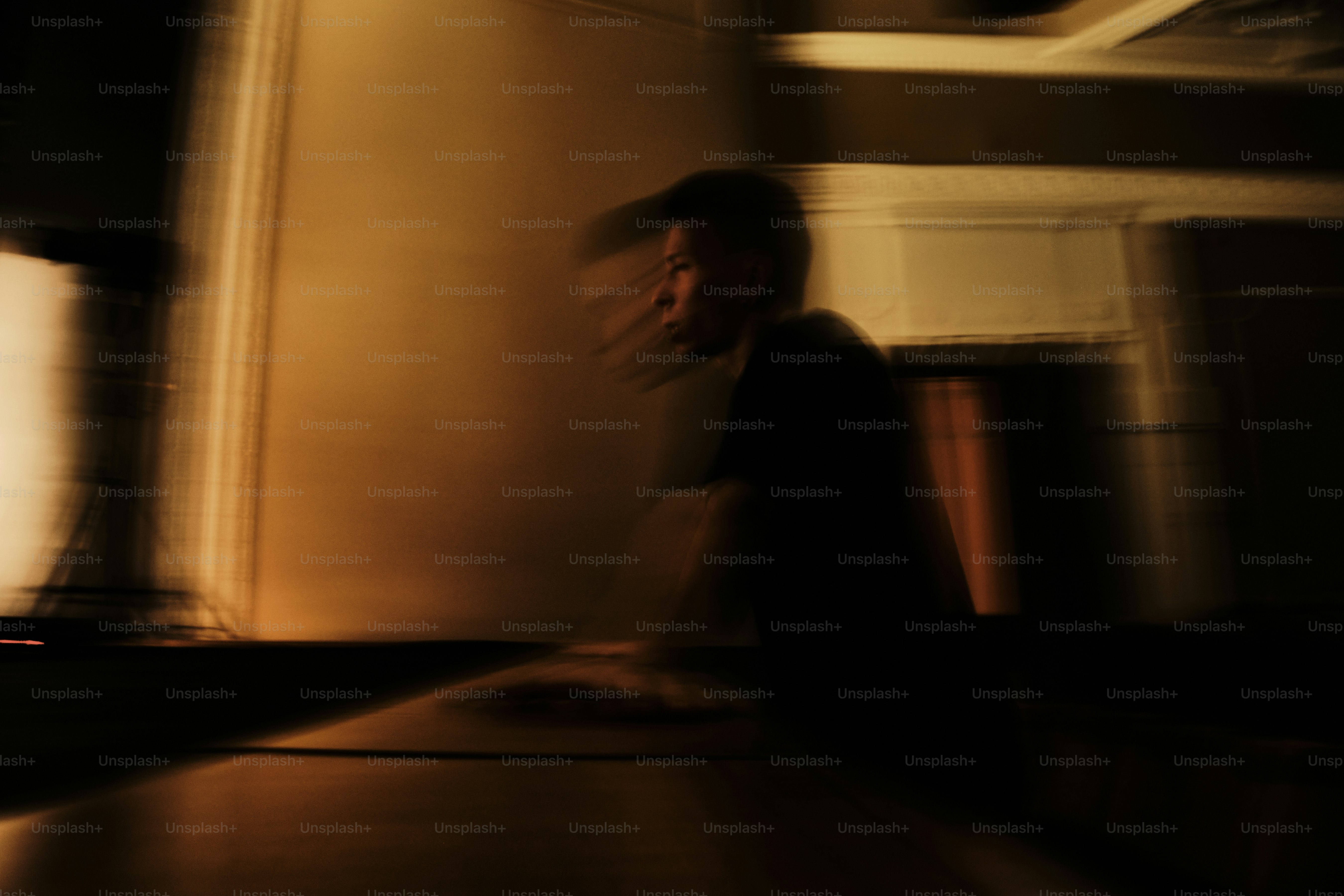 A blurry photo of a person walking in a kitchen