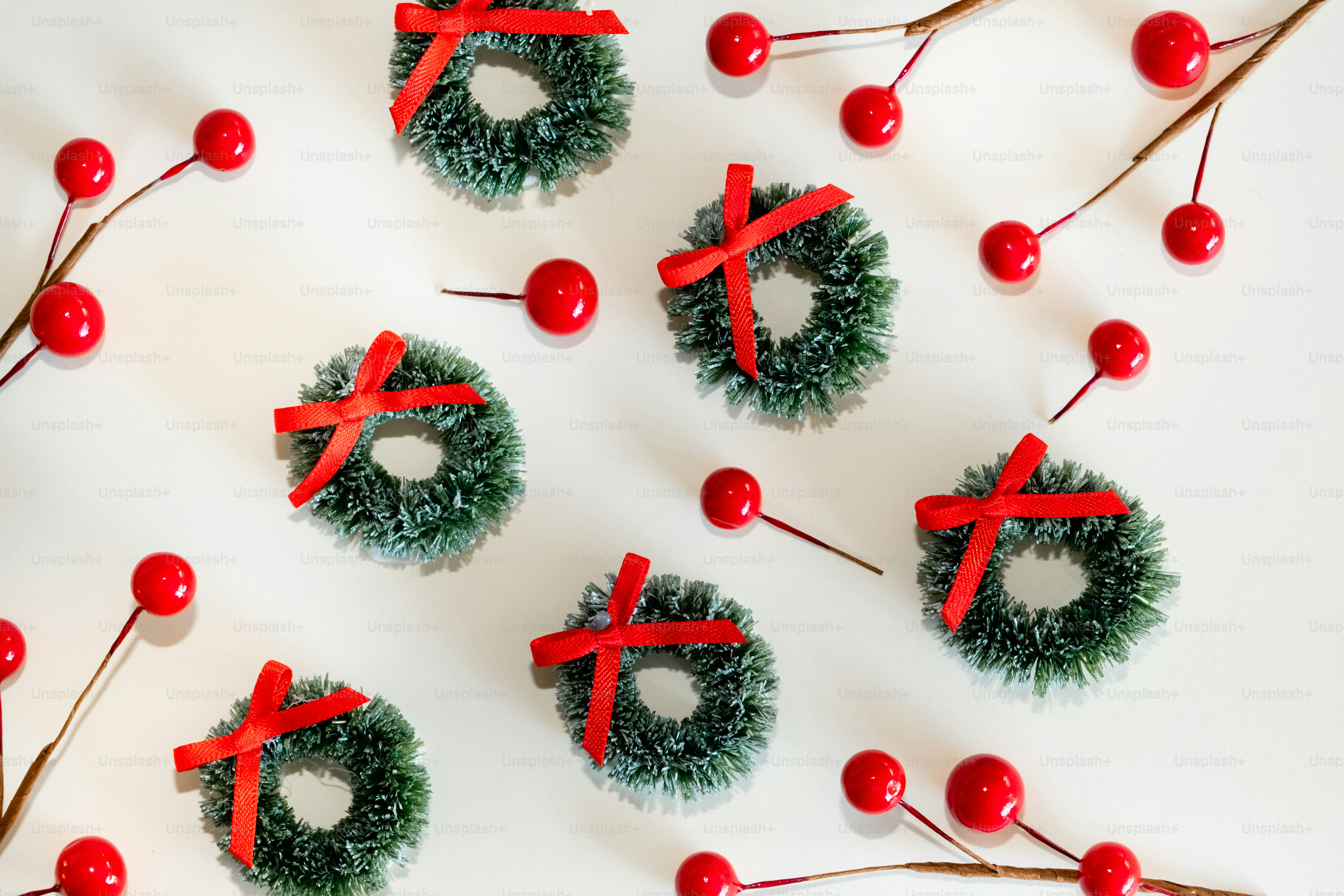 A bunch of wreaths with red bows on them
