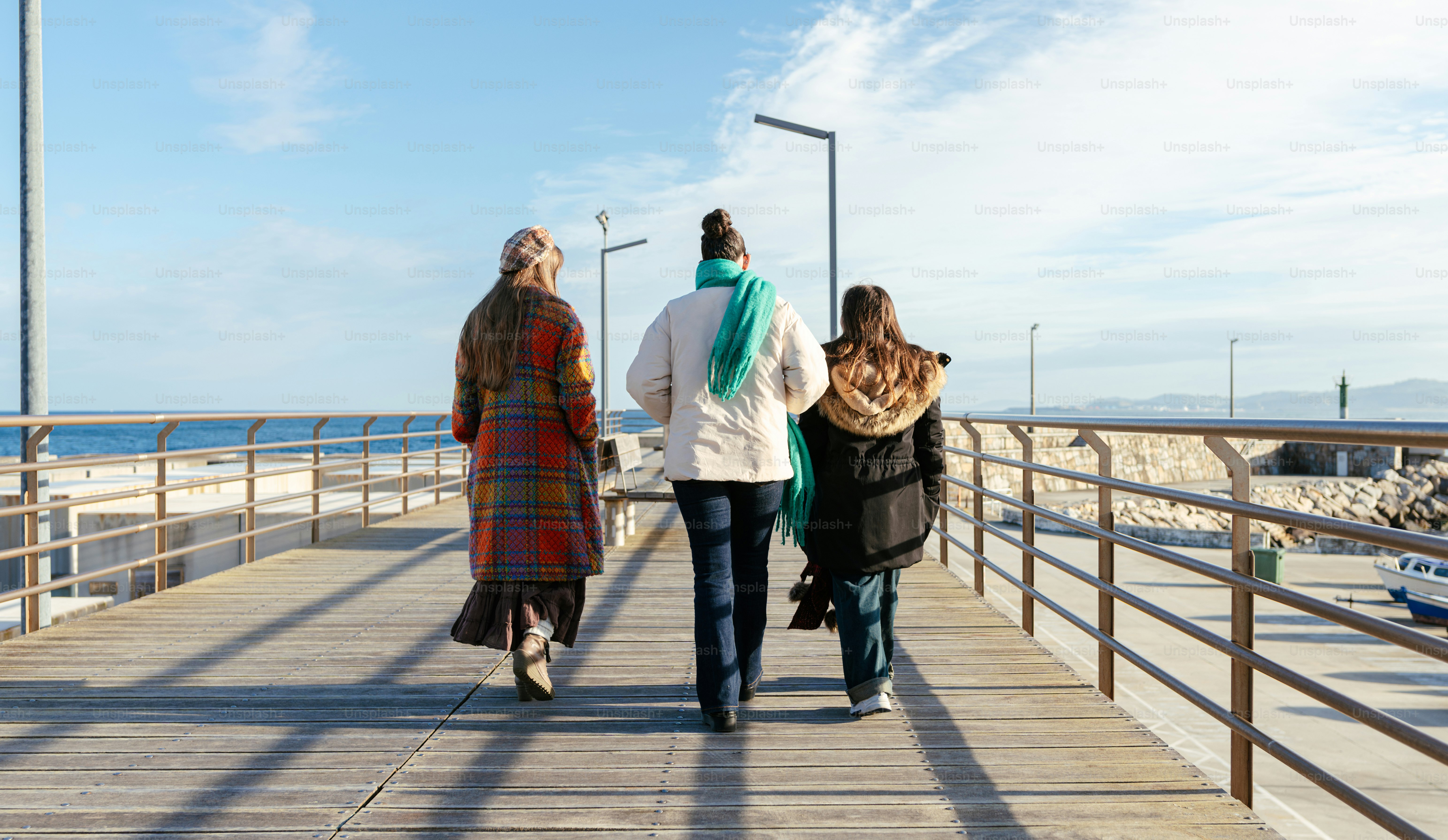 A group of people walking down a pier