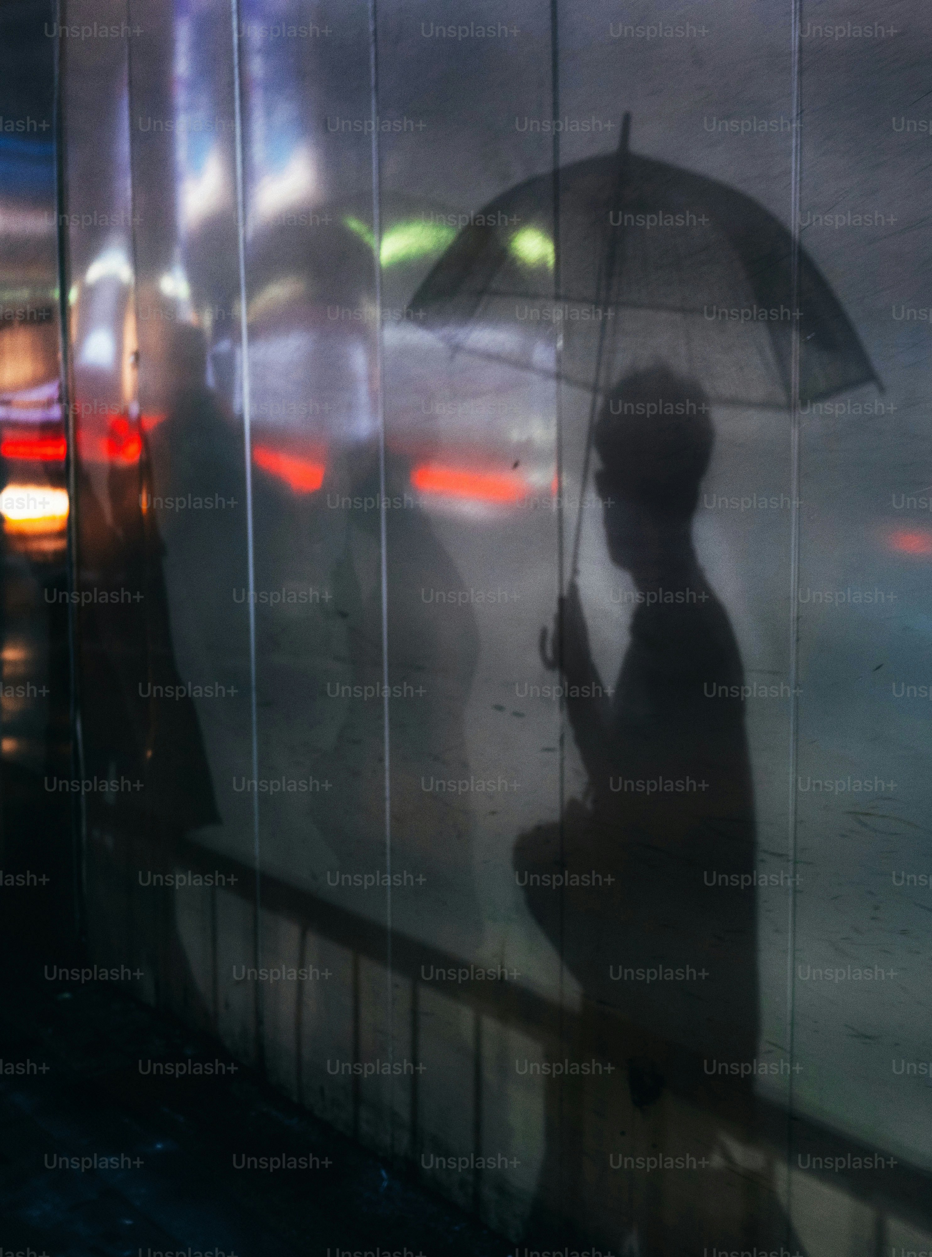 A reflection of a person holding an umbrella