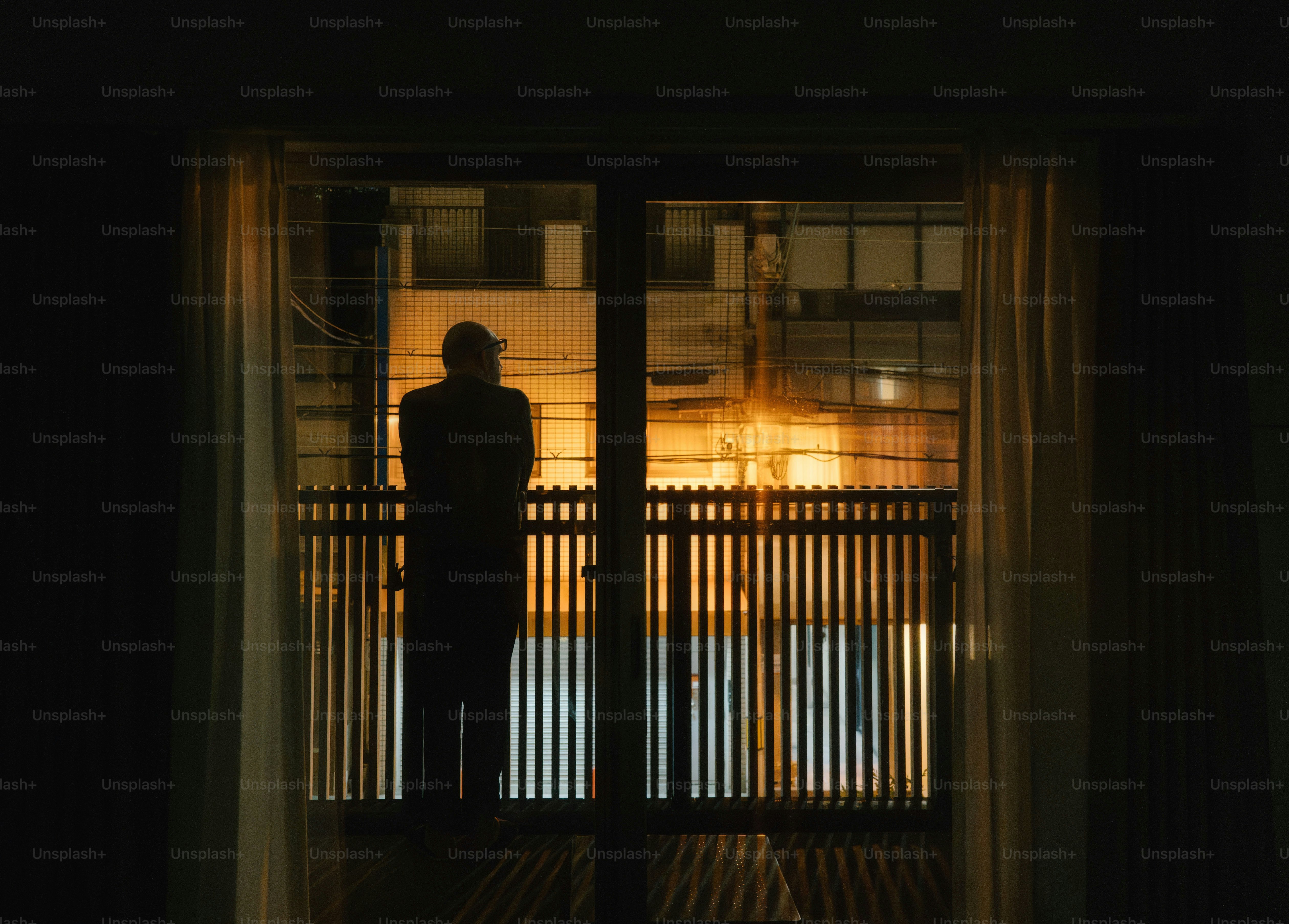 A person standing in front of a door at night