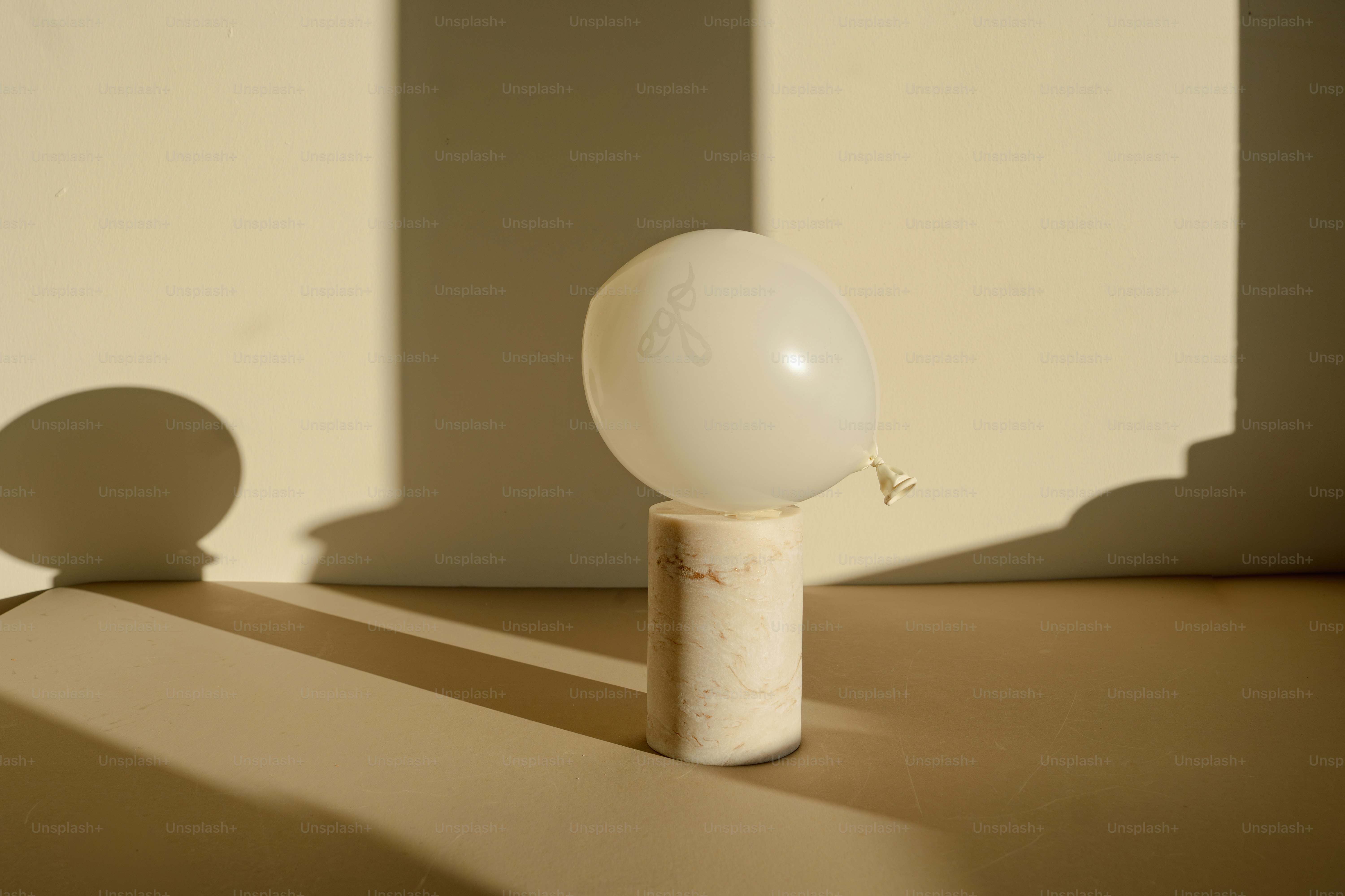 A white ball sitting on top of a wooden pole