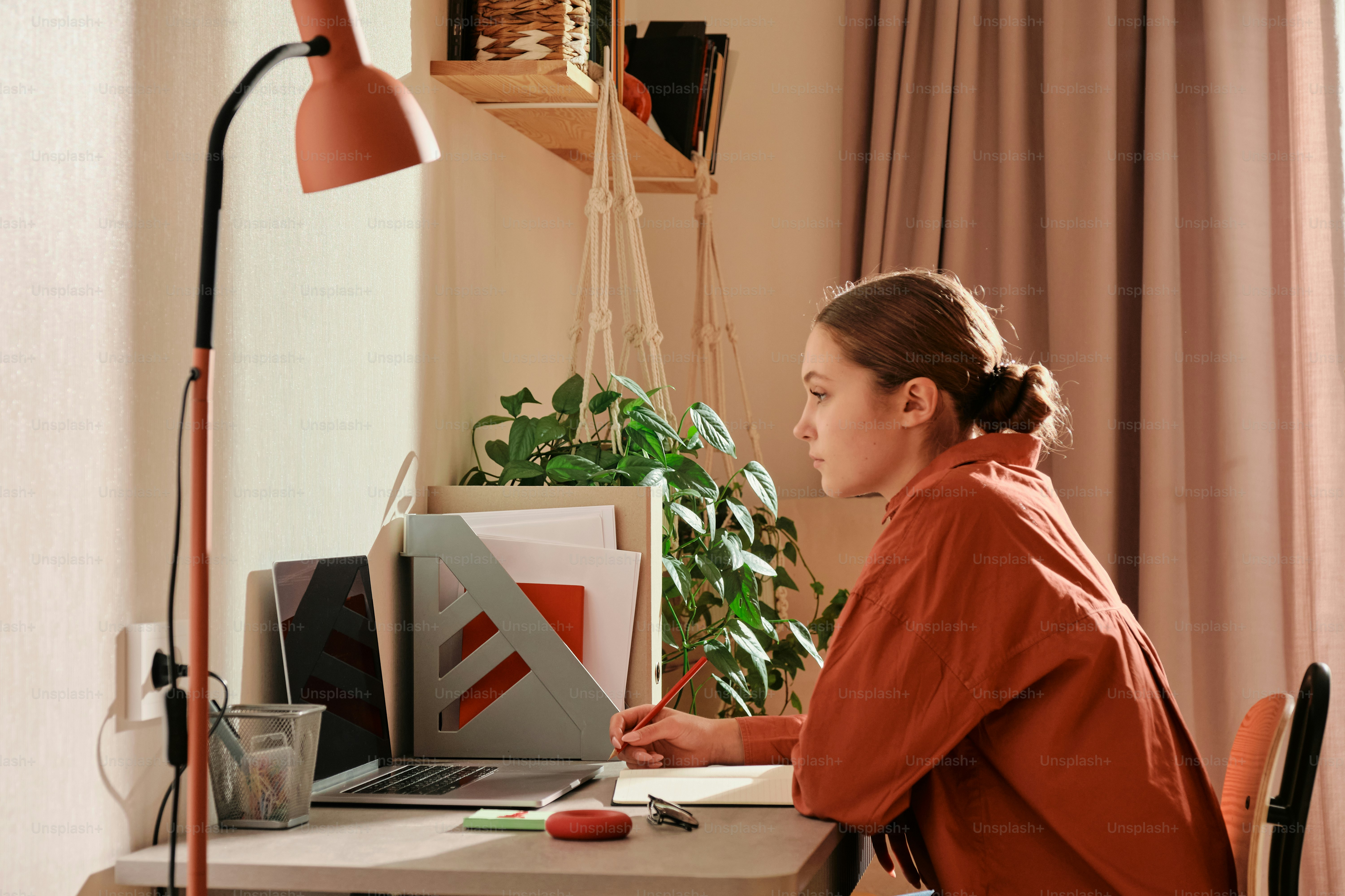 A woman sitting at a desk using a laptop computer