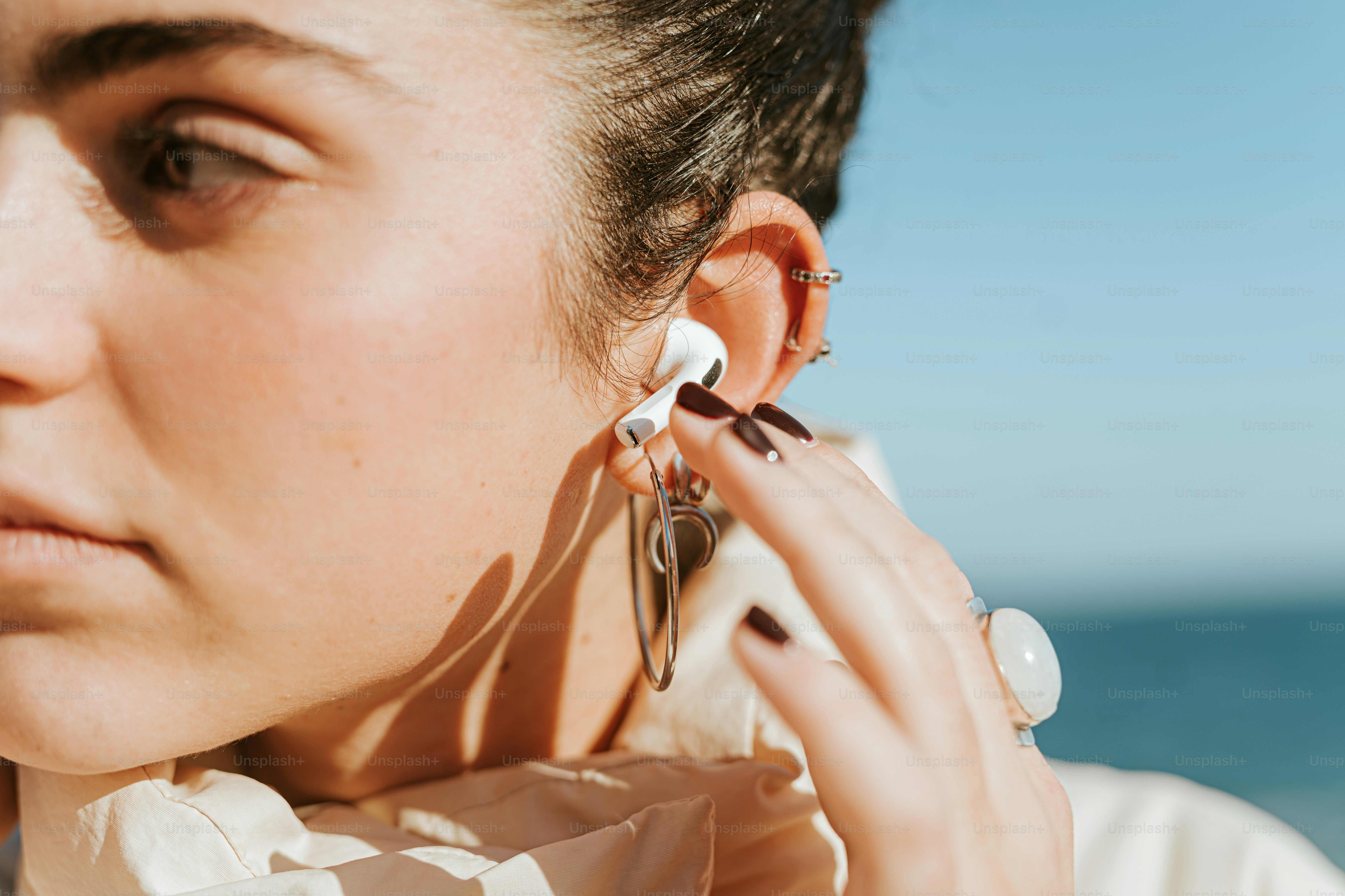 A woman wearing a pair of earrings on her ear