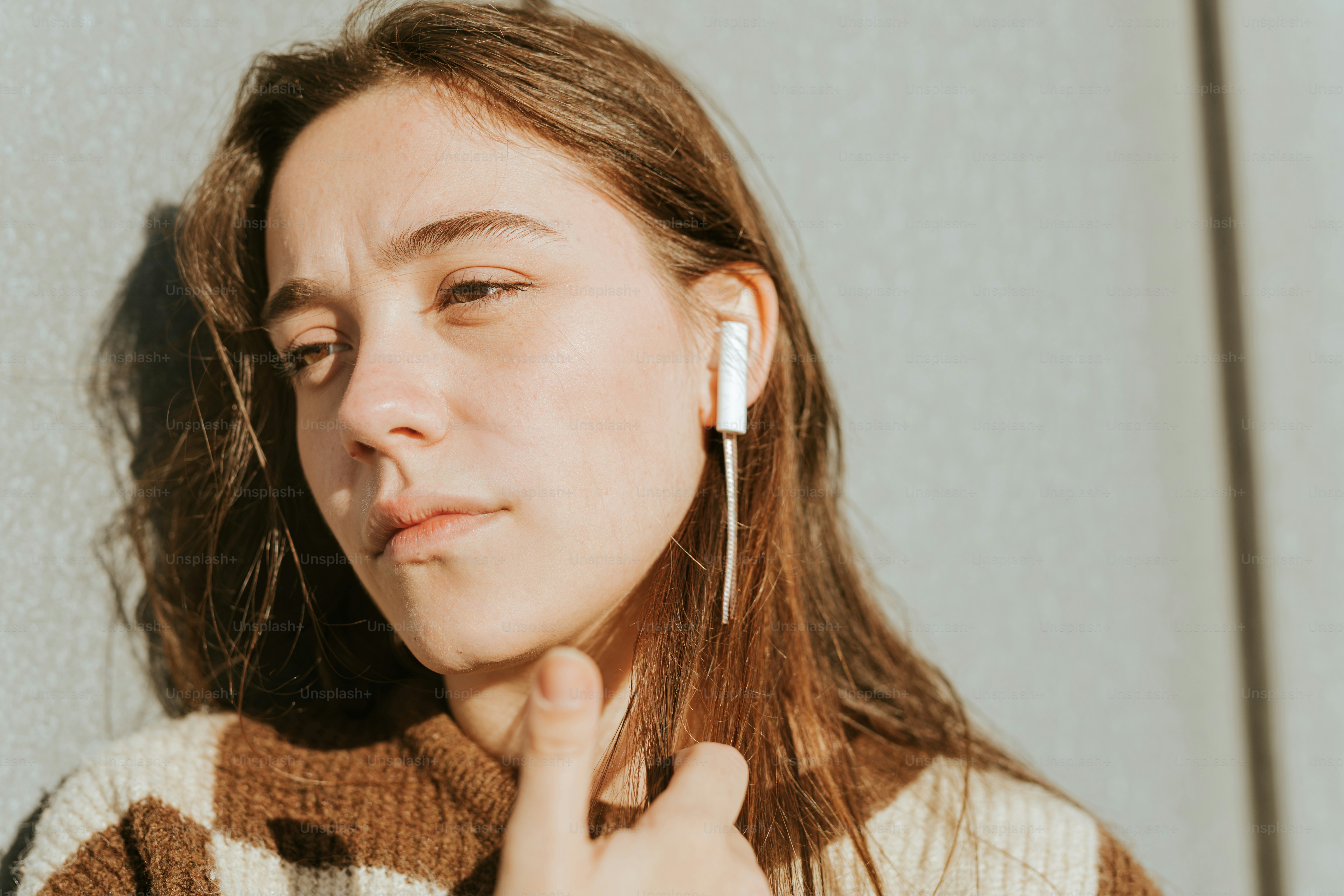 A woman with ear buds on her ears