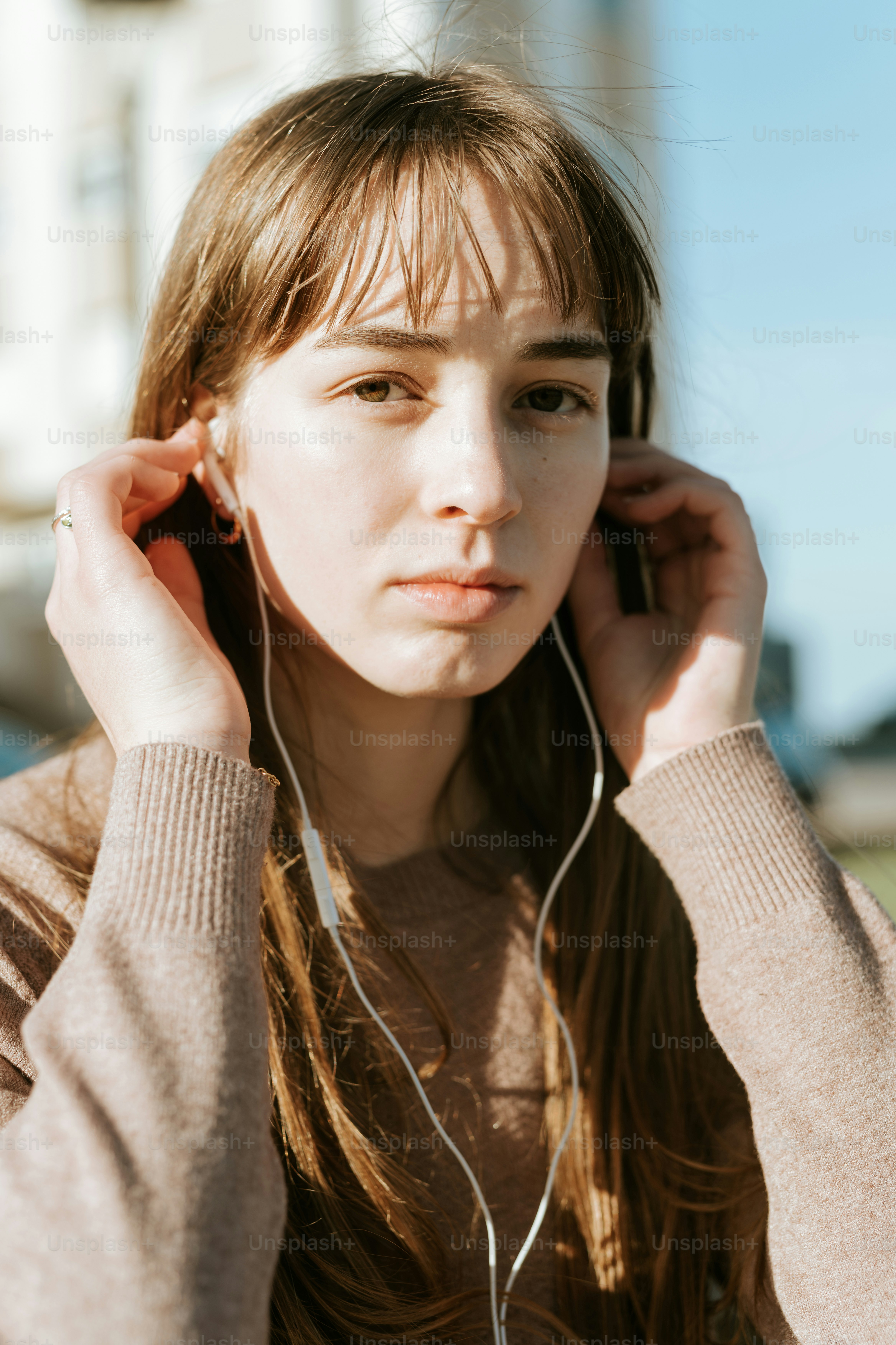 A young woman listening to music with headphones