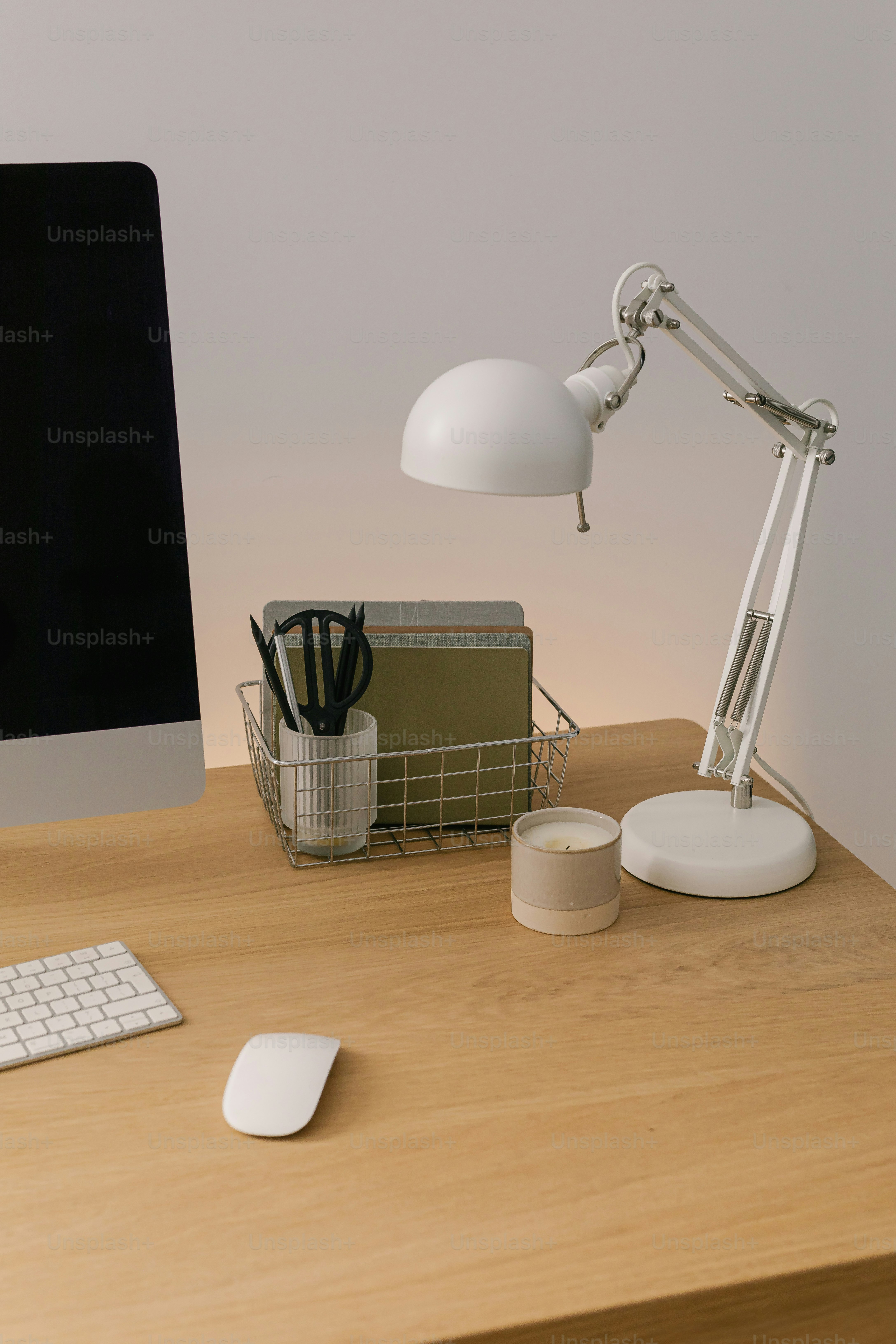 A desk with a monitor, keyboard and mouse