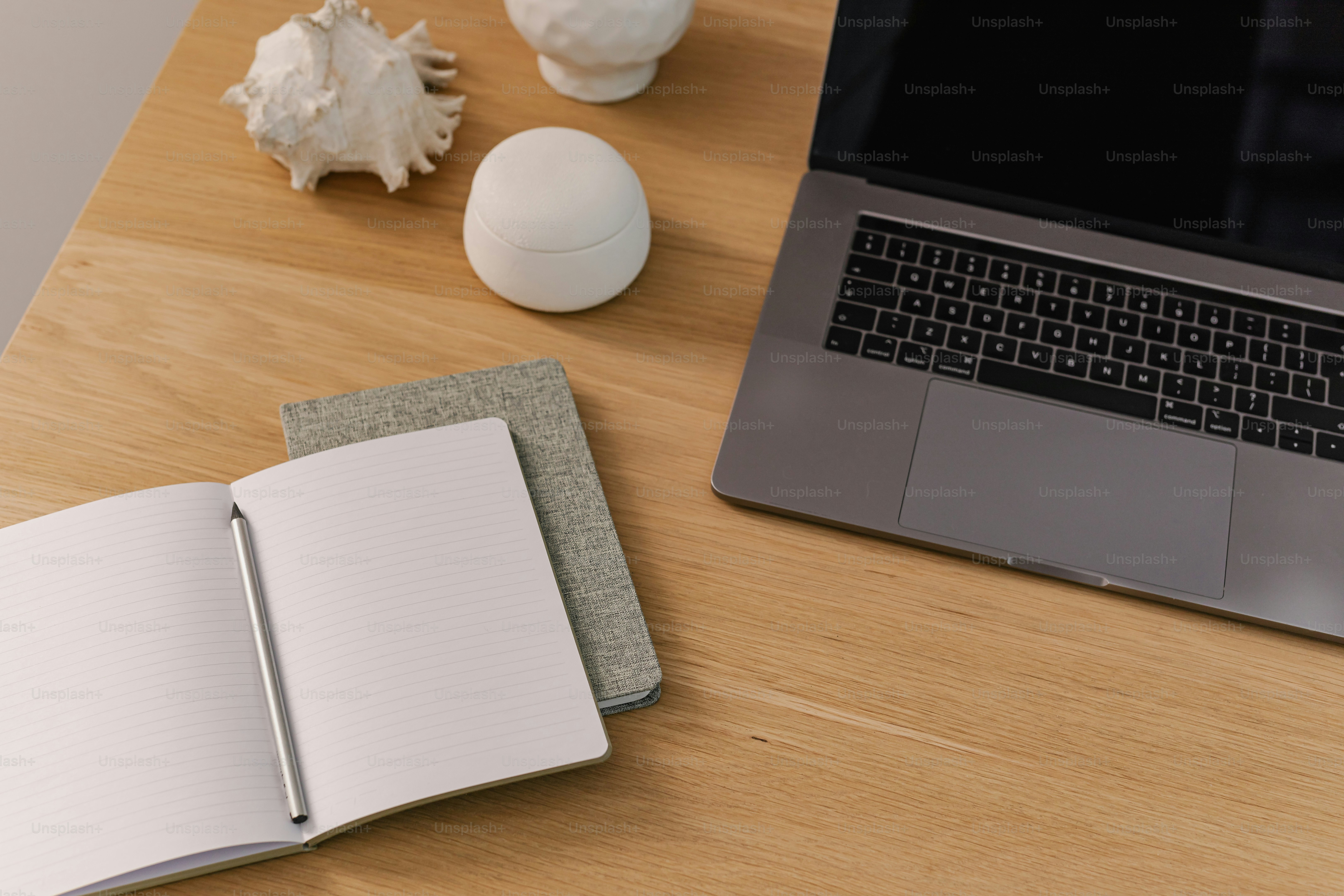 A laptop computer sitting on top of a wooden desk