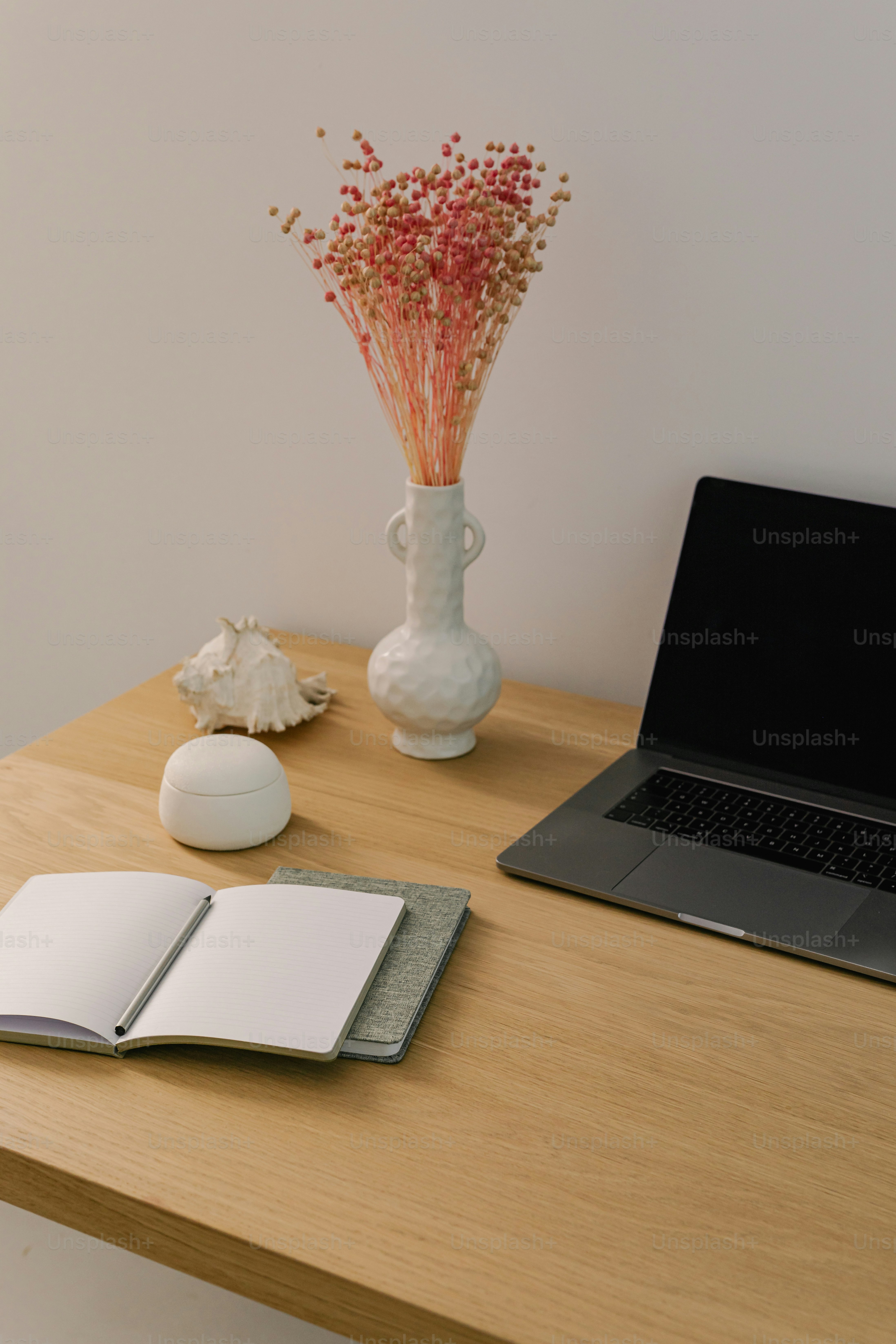 A laptop computer sitting on top of a wooden desk