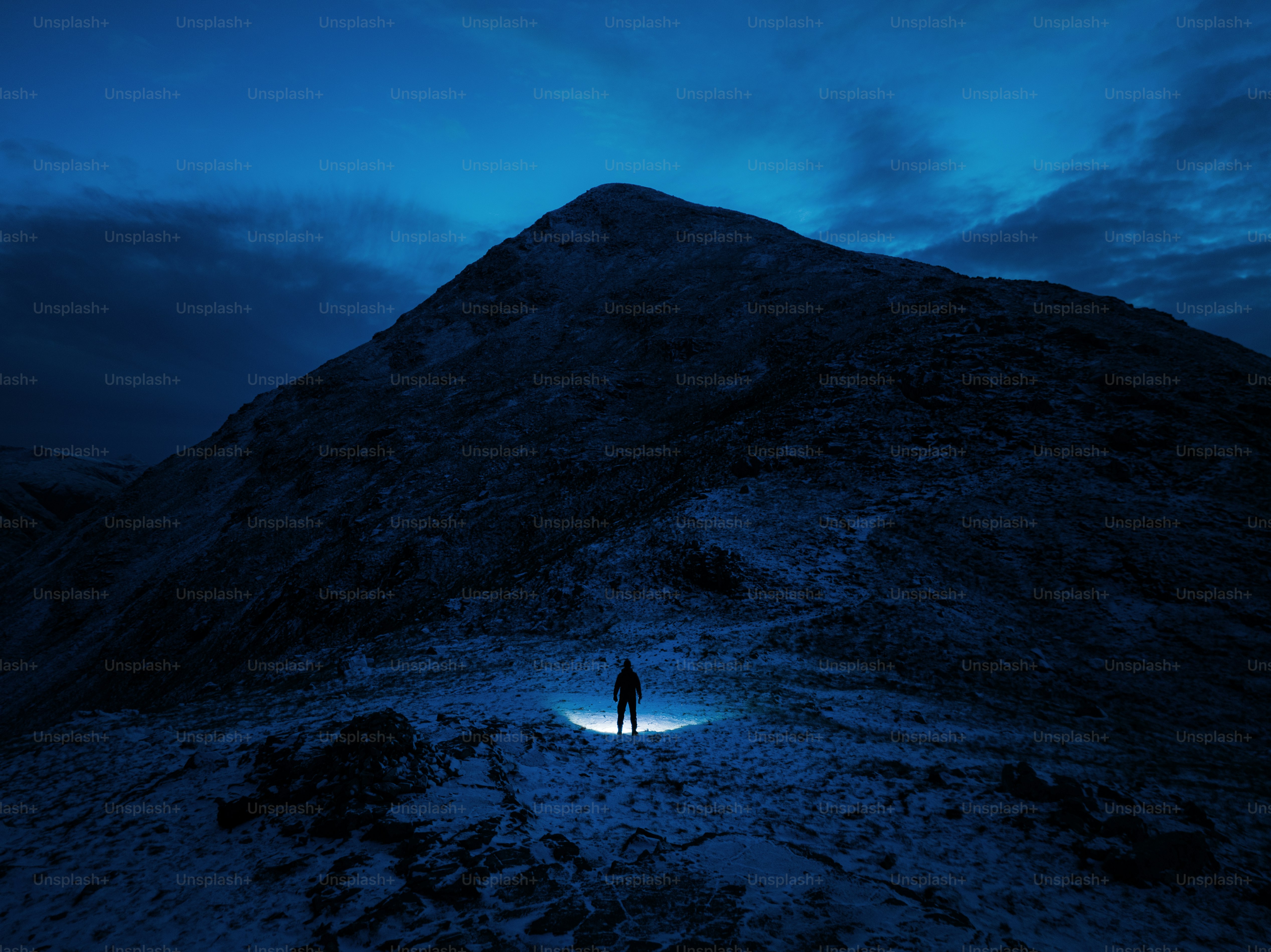 A person standing on top of a snow covered mountain