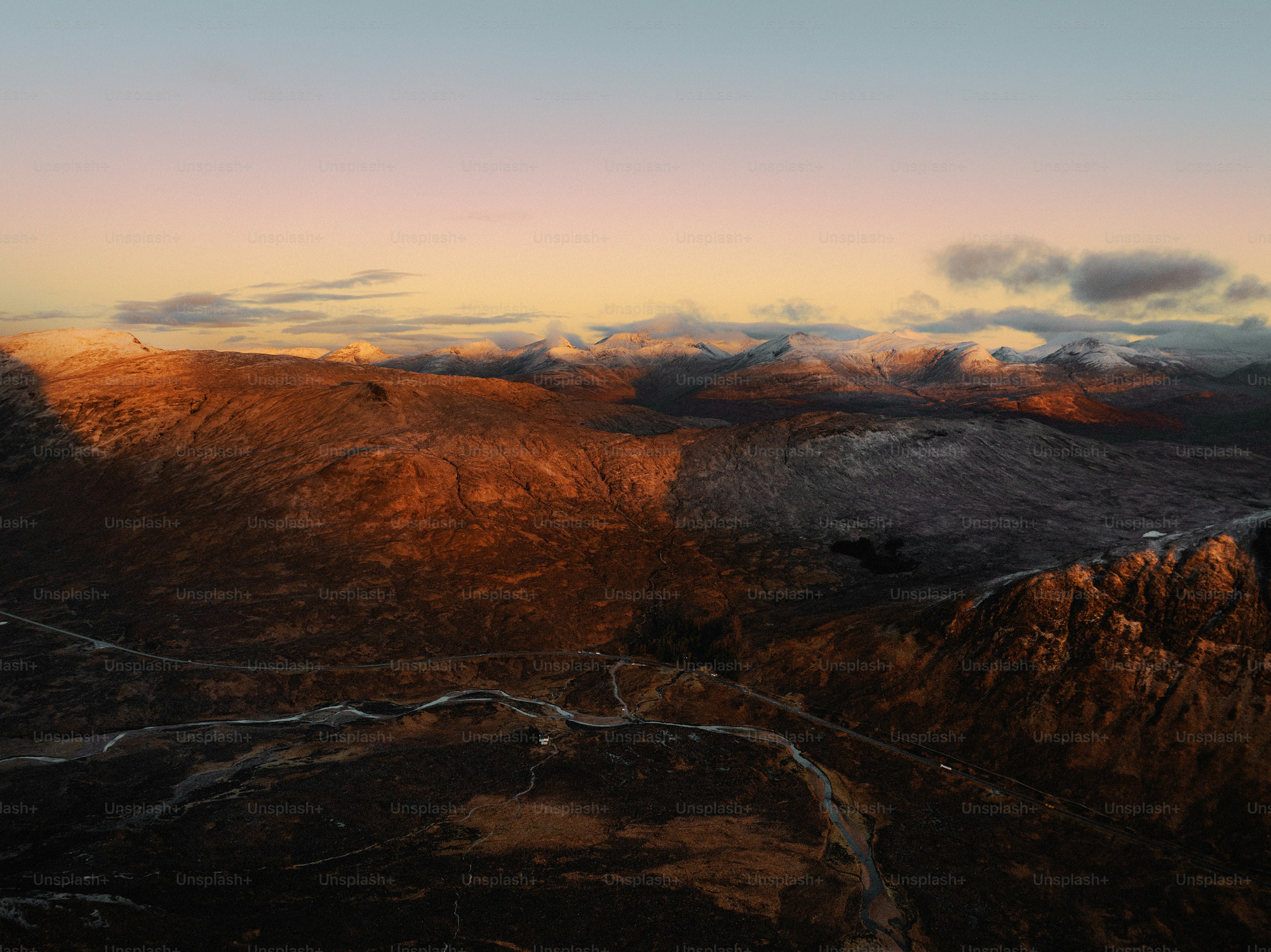 An aerial view of a mountain range at sunset
