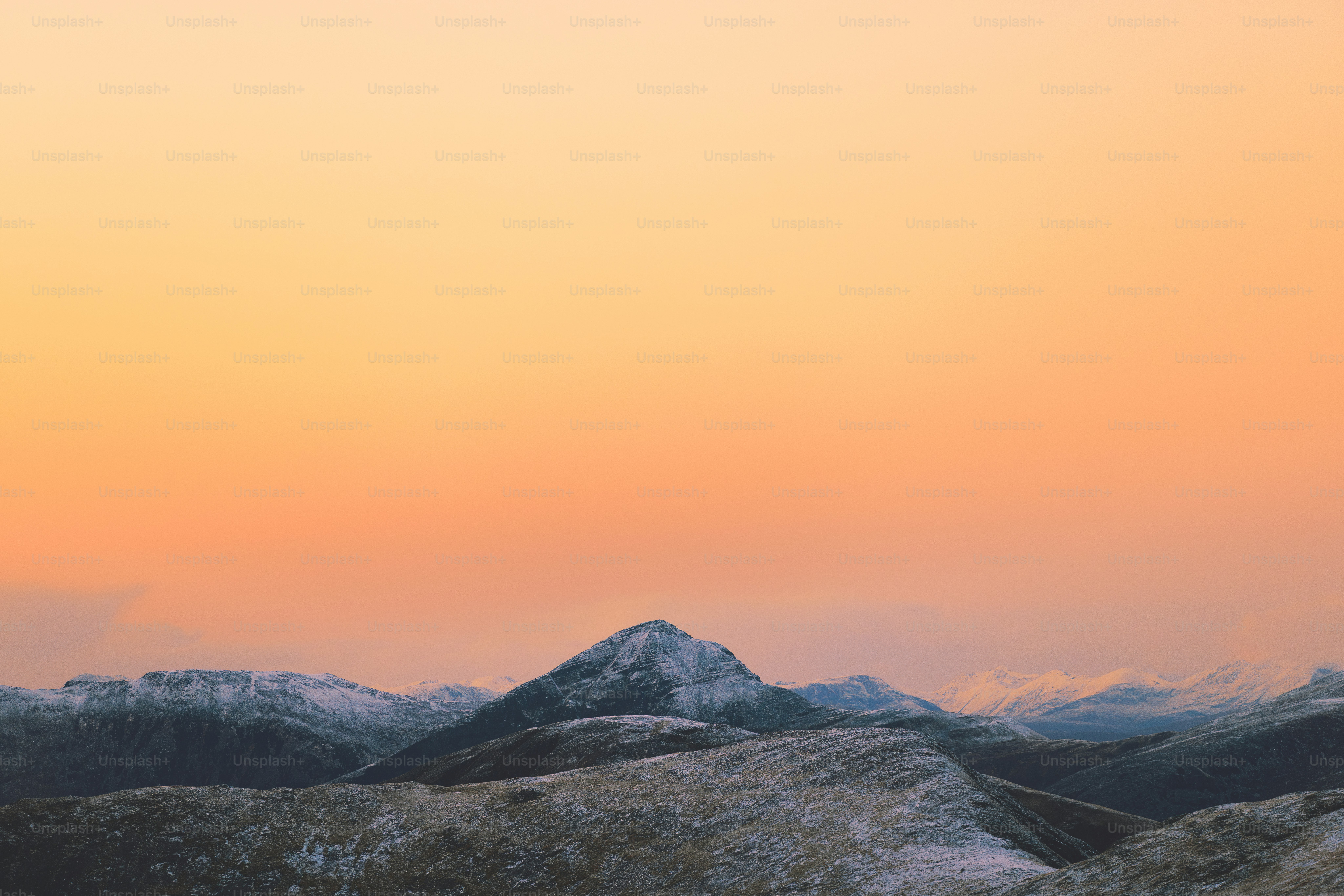 A man standing on top of a snow covered mountain