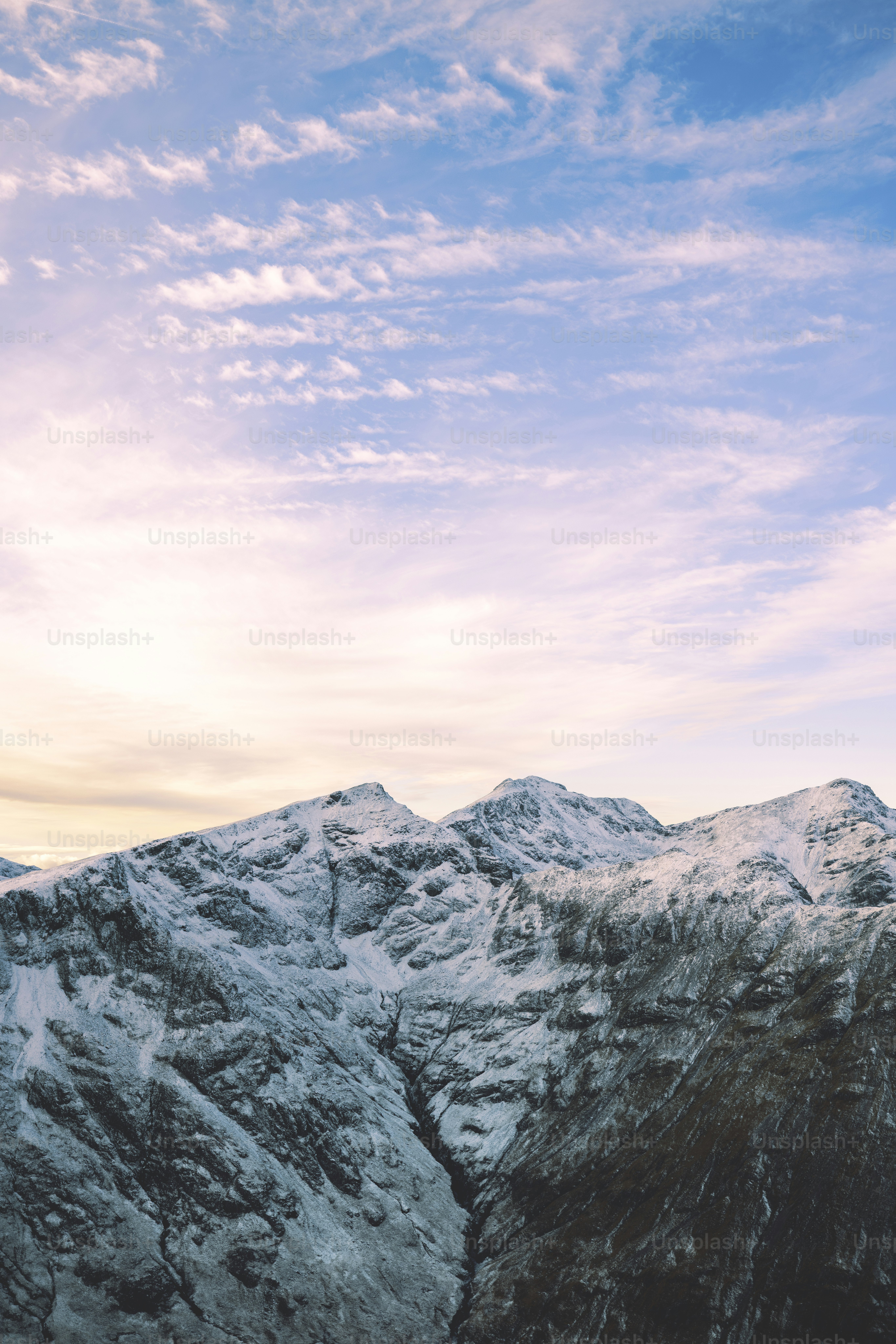 A view of a mountain range with snow on it photo – Travel Image on Unsplash