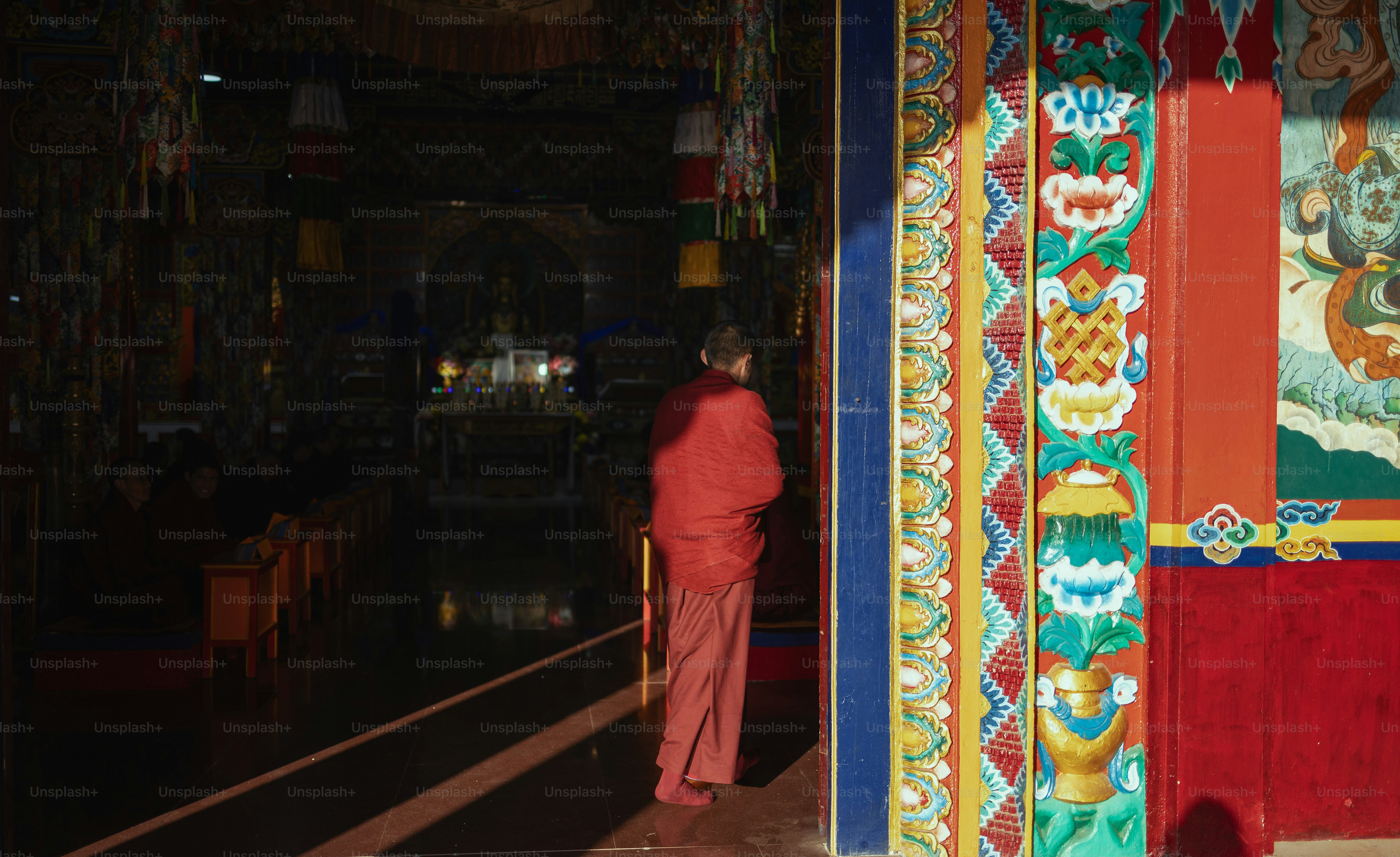 A person standing in front of a colorful building