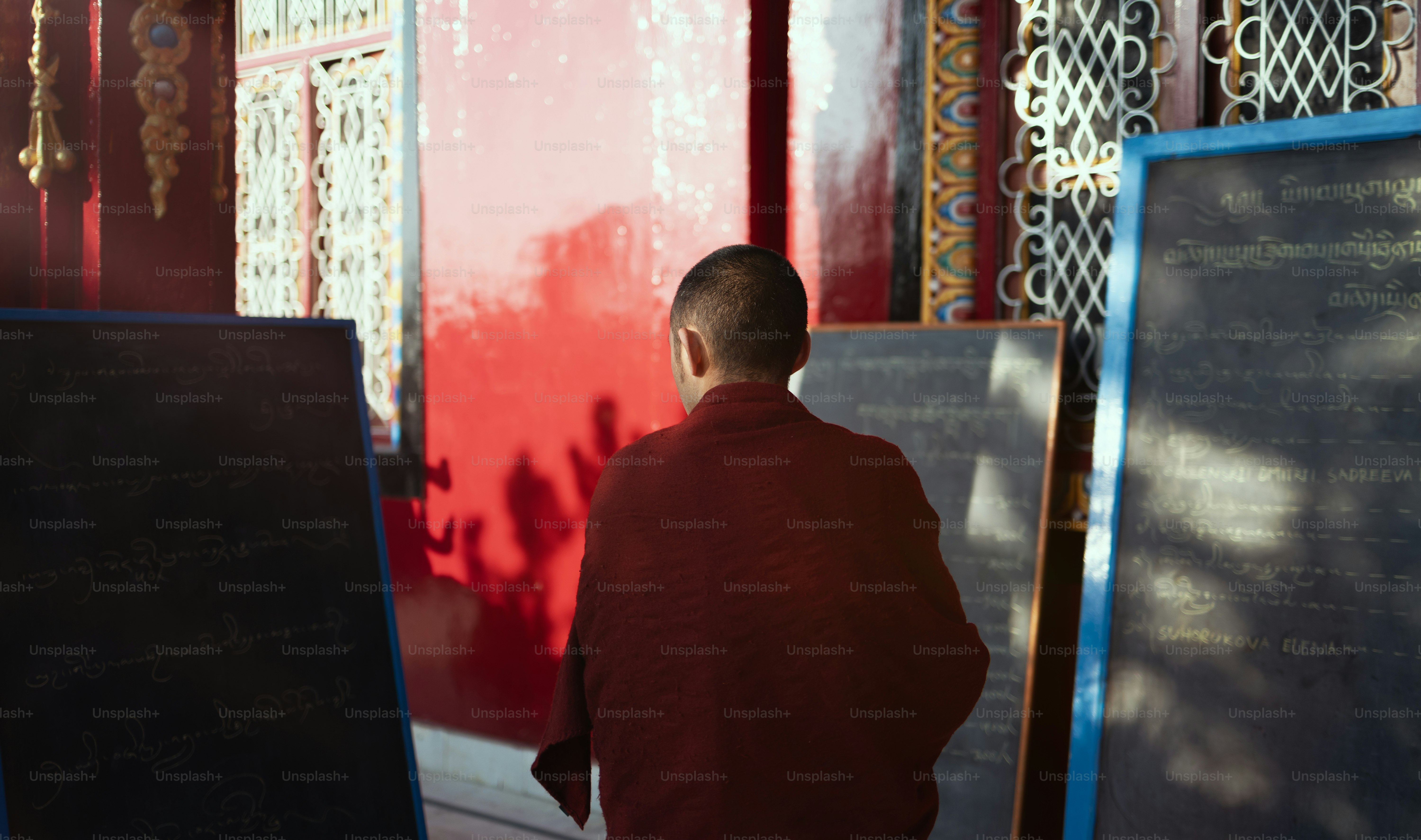 A man standing in front of a red wall photo – India Image on Unsplash
