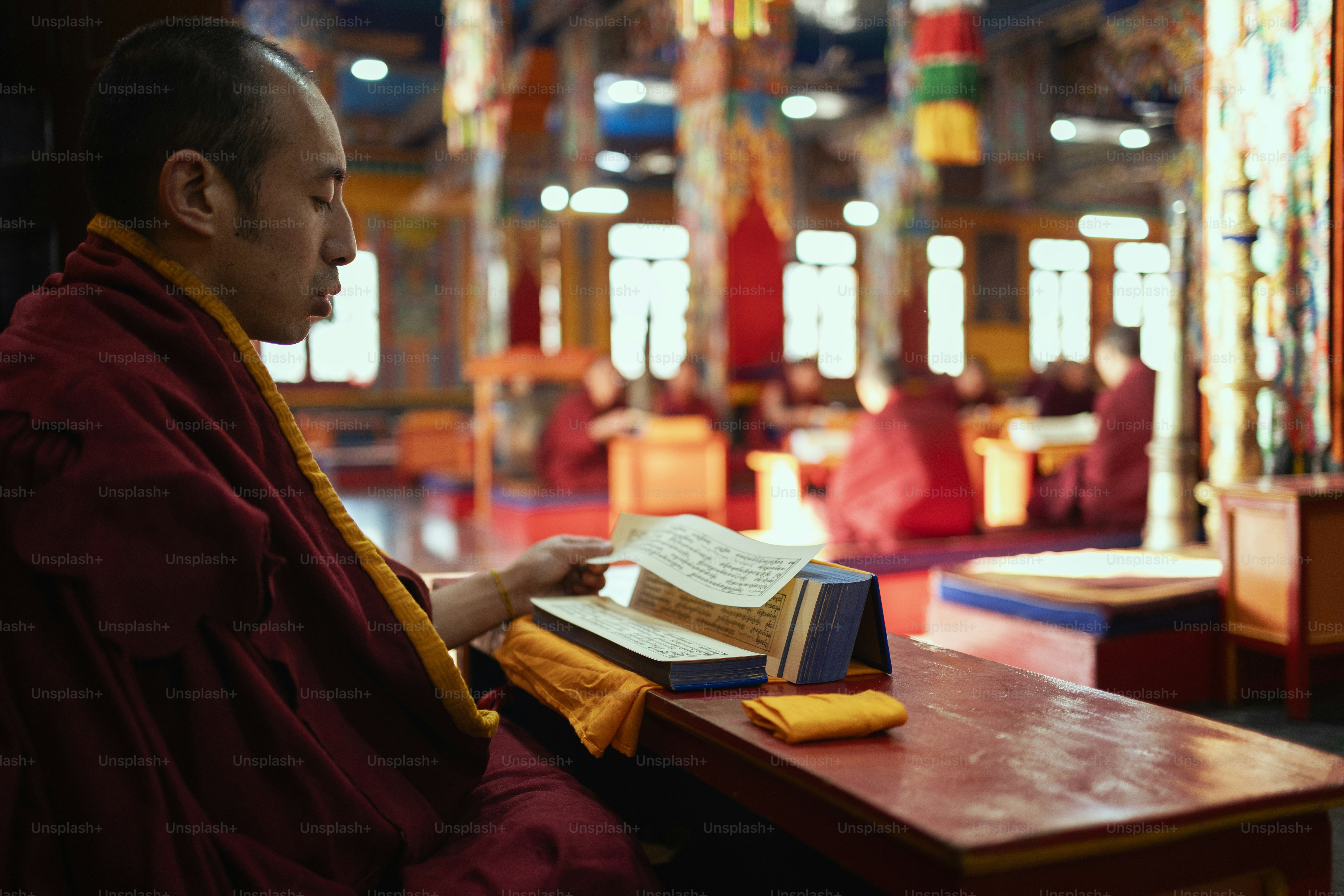 A man sitting at a desk with a book in front of him