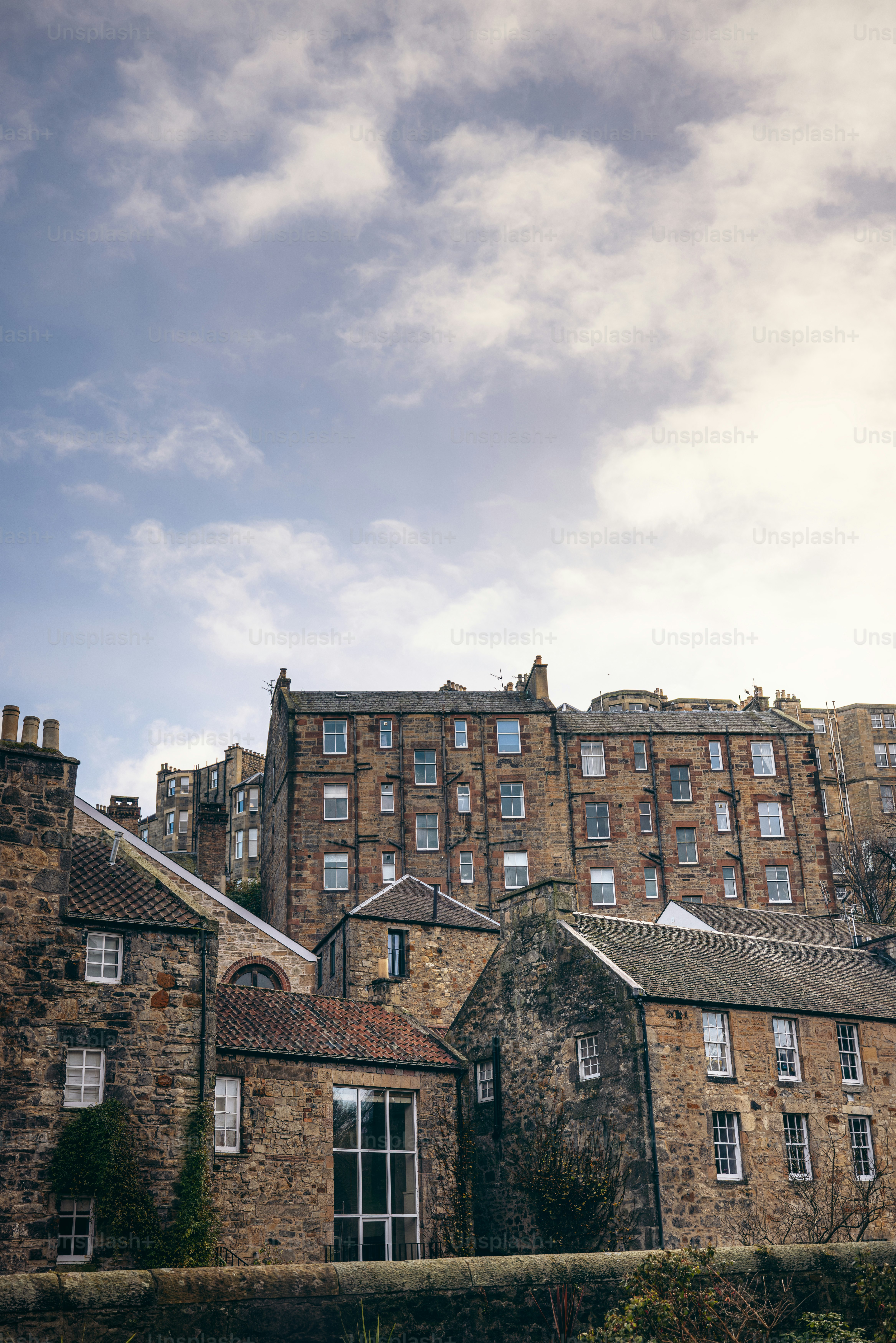 A large building with many windows and a sky background