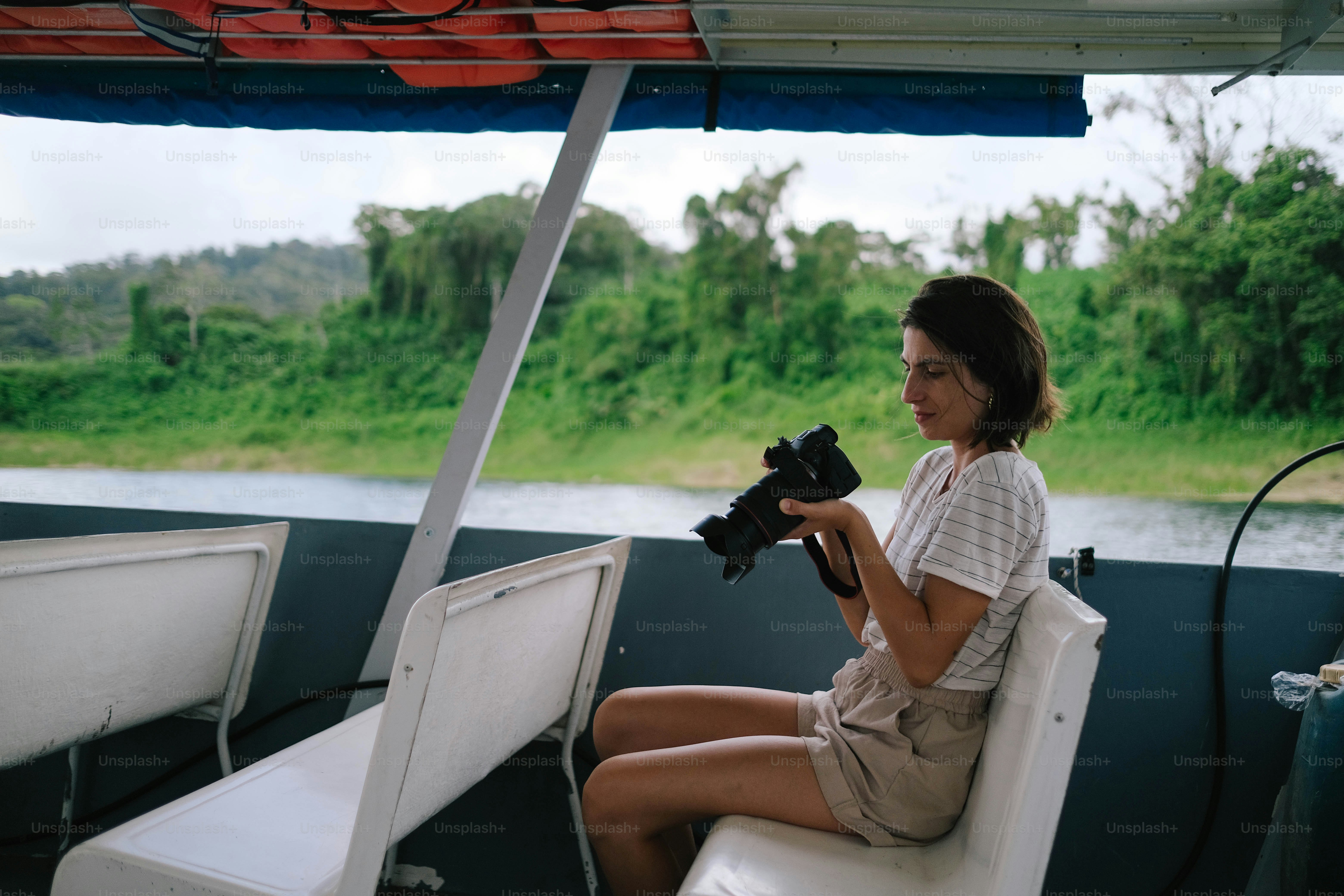 A woman sitting on a boat holding a glove