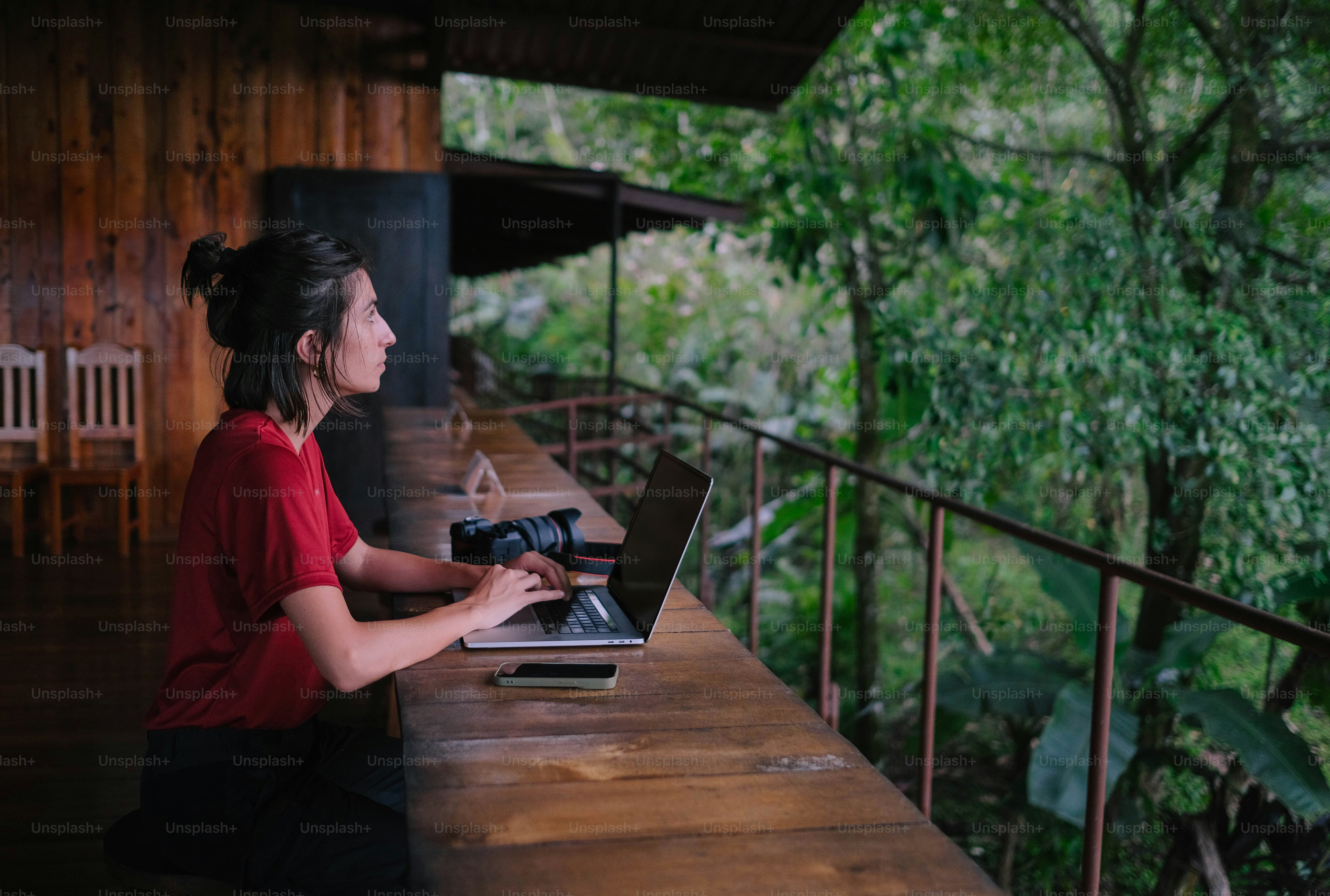 A woman sitting at a table using a laptop computer