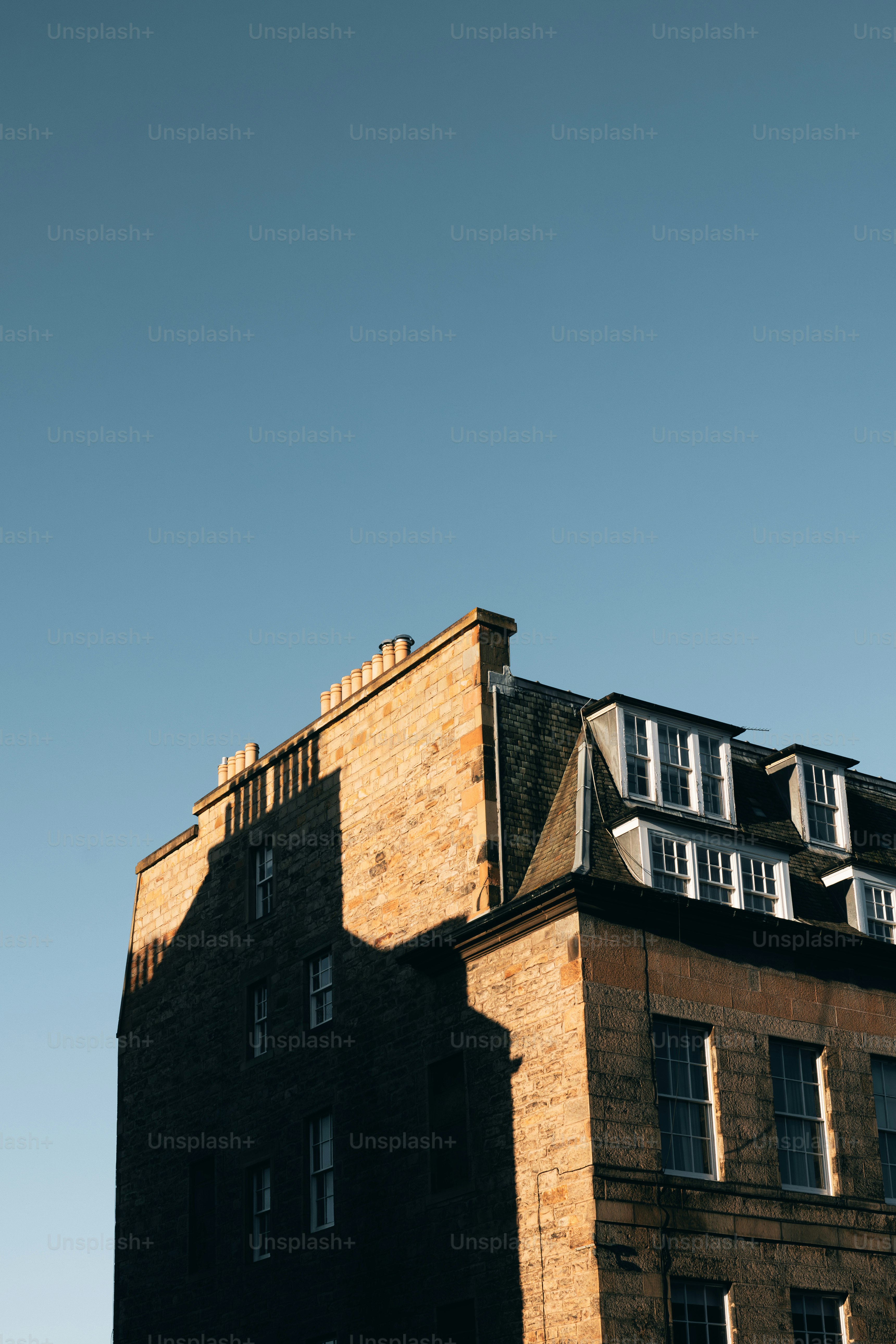 A tall brick building with a clock on the top of it
