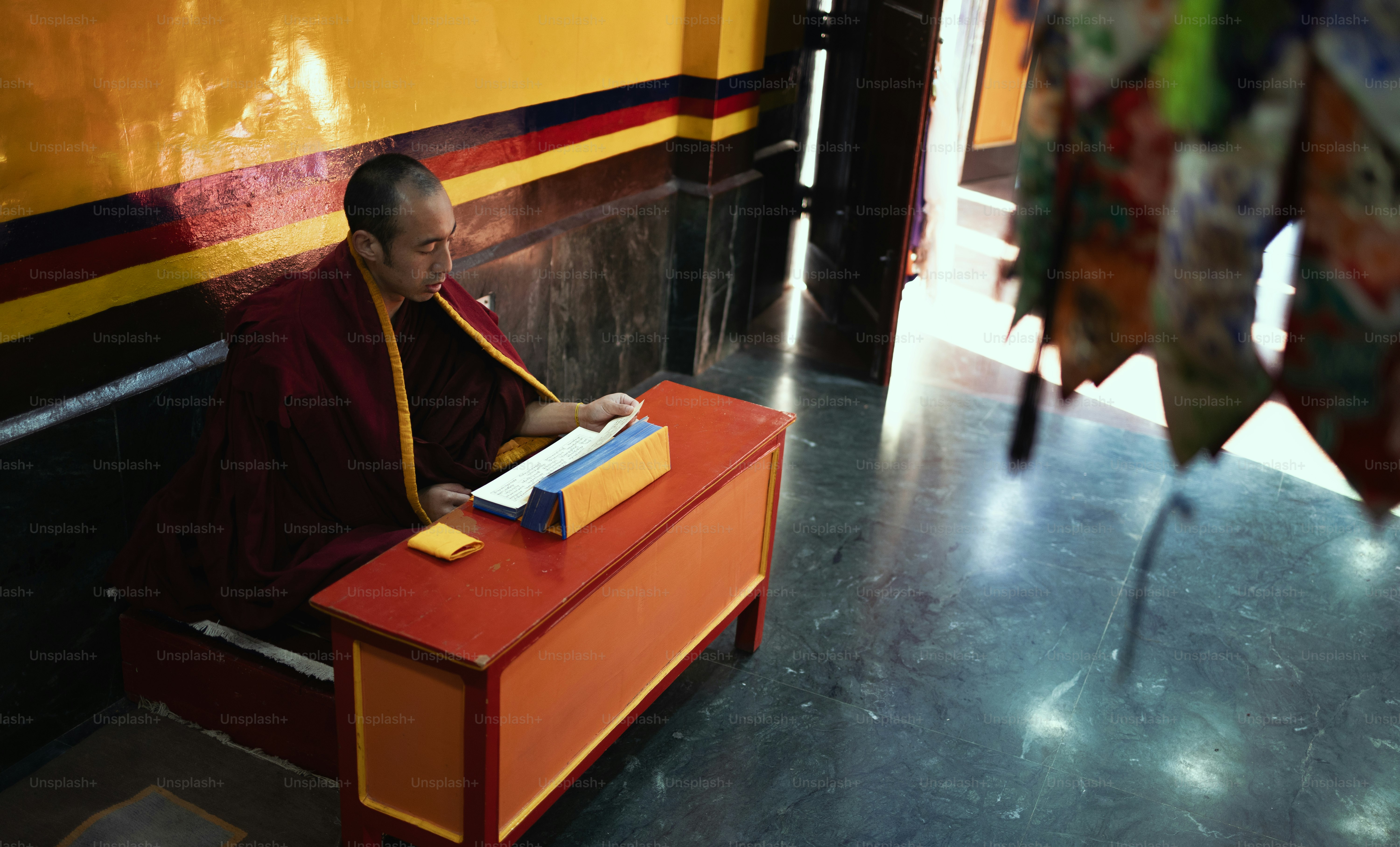 A man sitting on a bench in front of a train