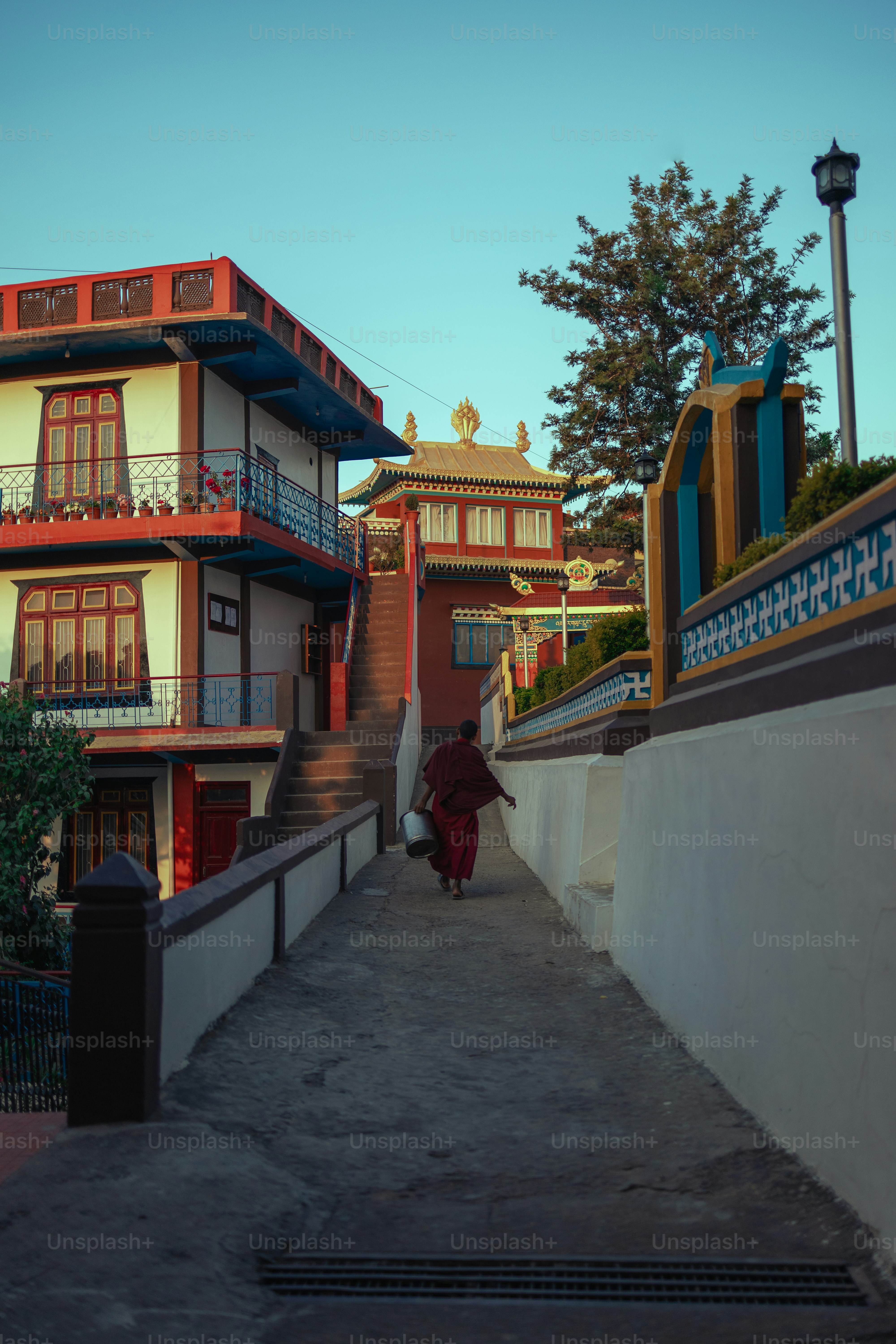 A person walking down a sidewalk next to a building