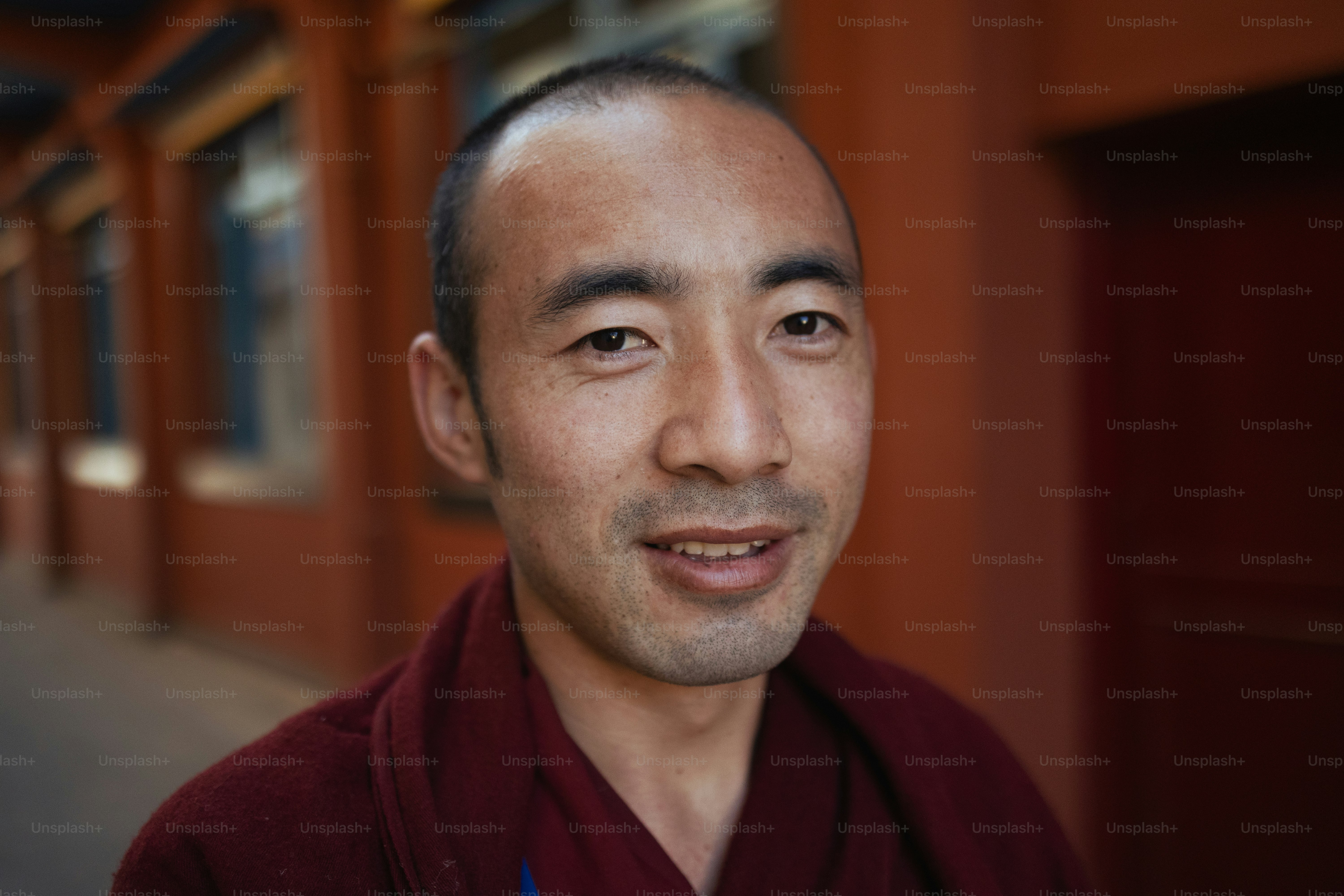 A man standing in front of a red building