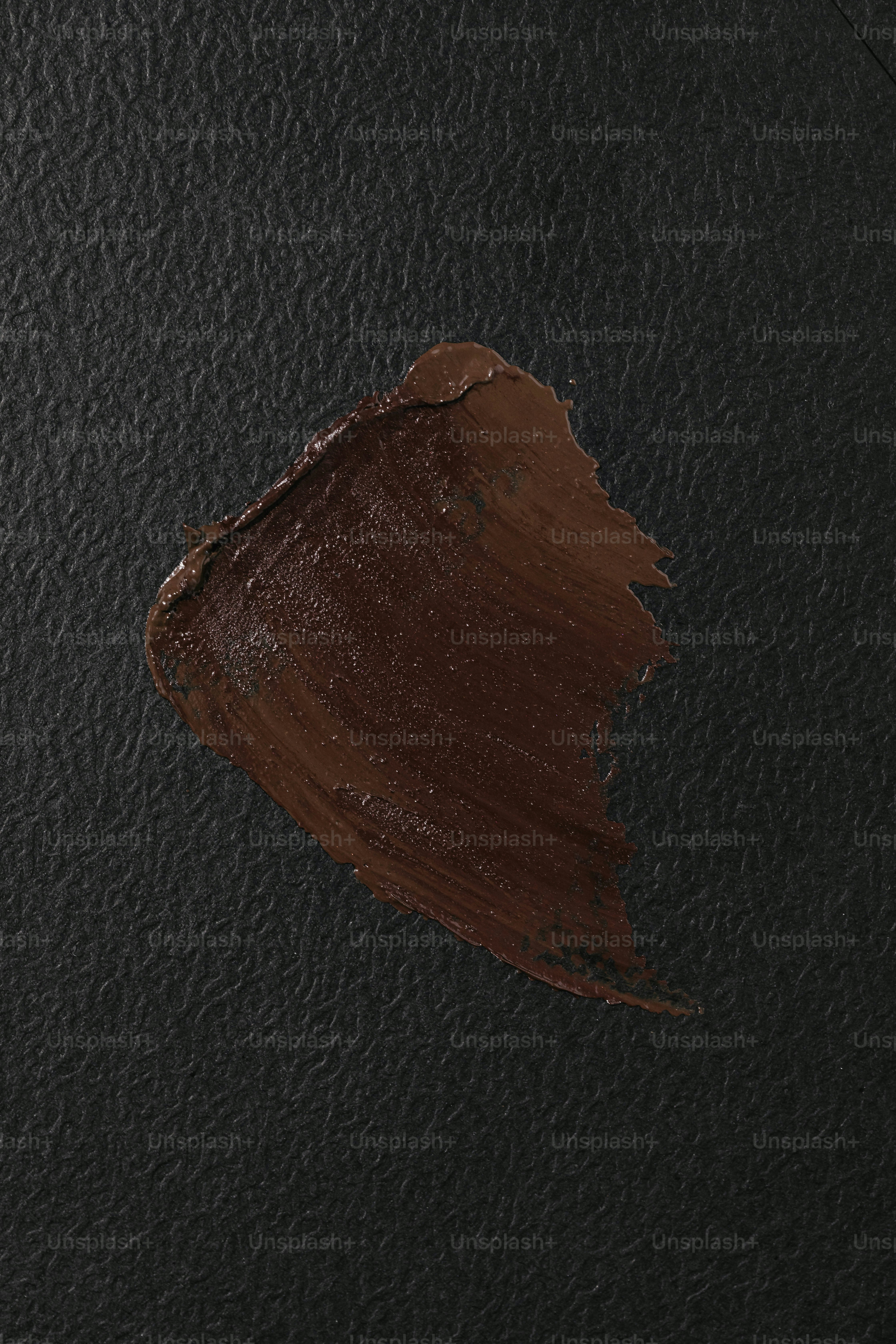 A close up of a brown liquid on a black surface